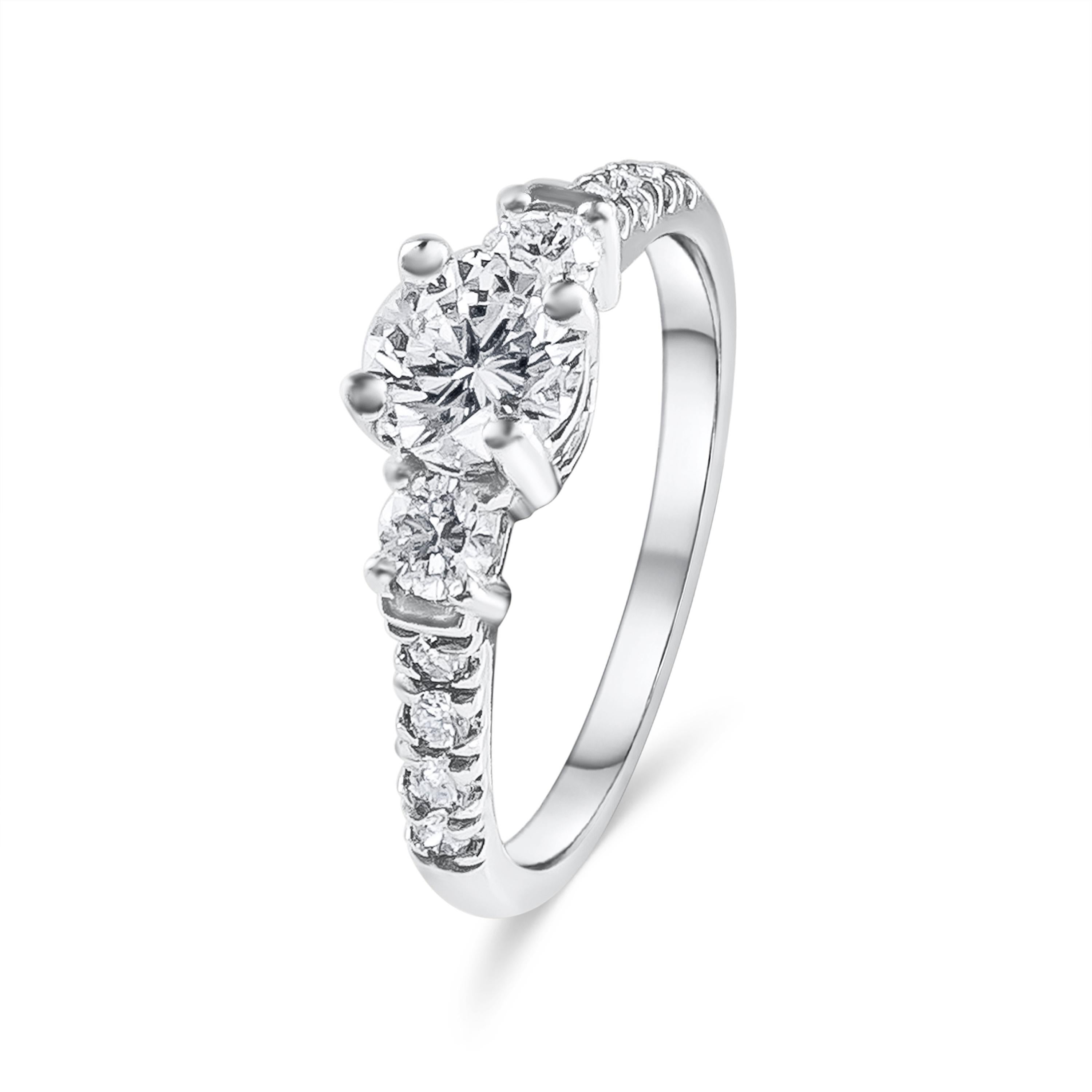 A lustrous engagement ring showcasing a 0.74 carat round brilliant diamond center that EGL USA Certified as H color, VS1 clarity. The center is flanked by 2 smaller round diamonds weighing 0.34 carats. Set in a polished platinum basket and band