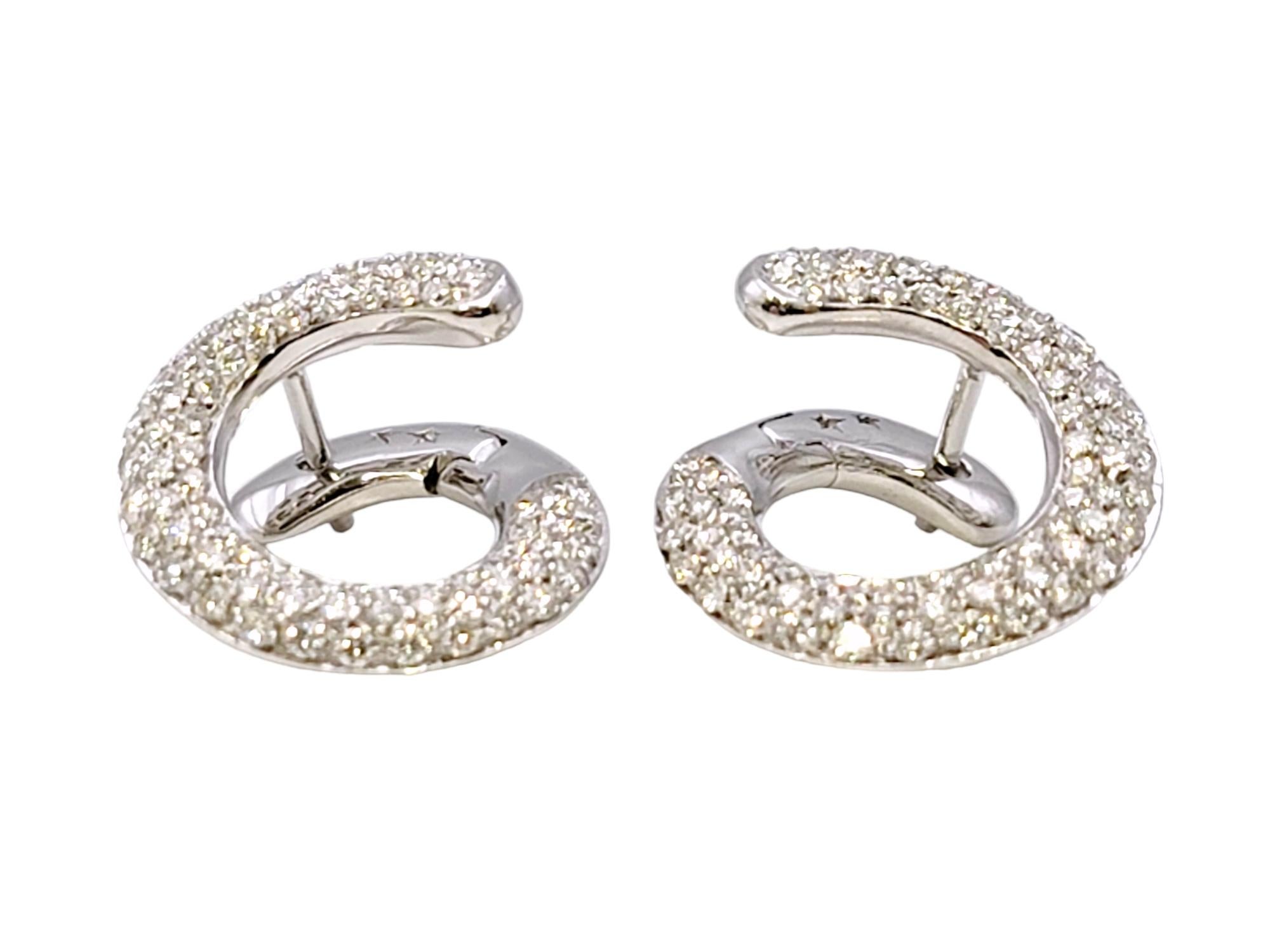 These super sparkly diamond swirl earrings absolutely glow. The playful modern design pops beautifully on the lobe, giving an understated yet glamorous look. 

These gorgeous earrings feature shimmering natural diamonds set throughout a single