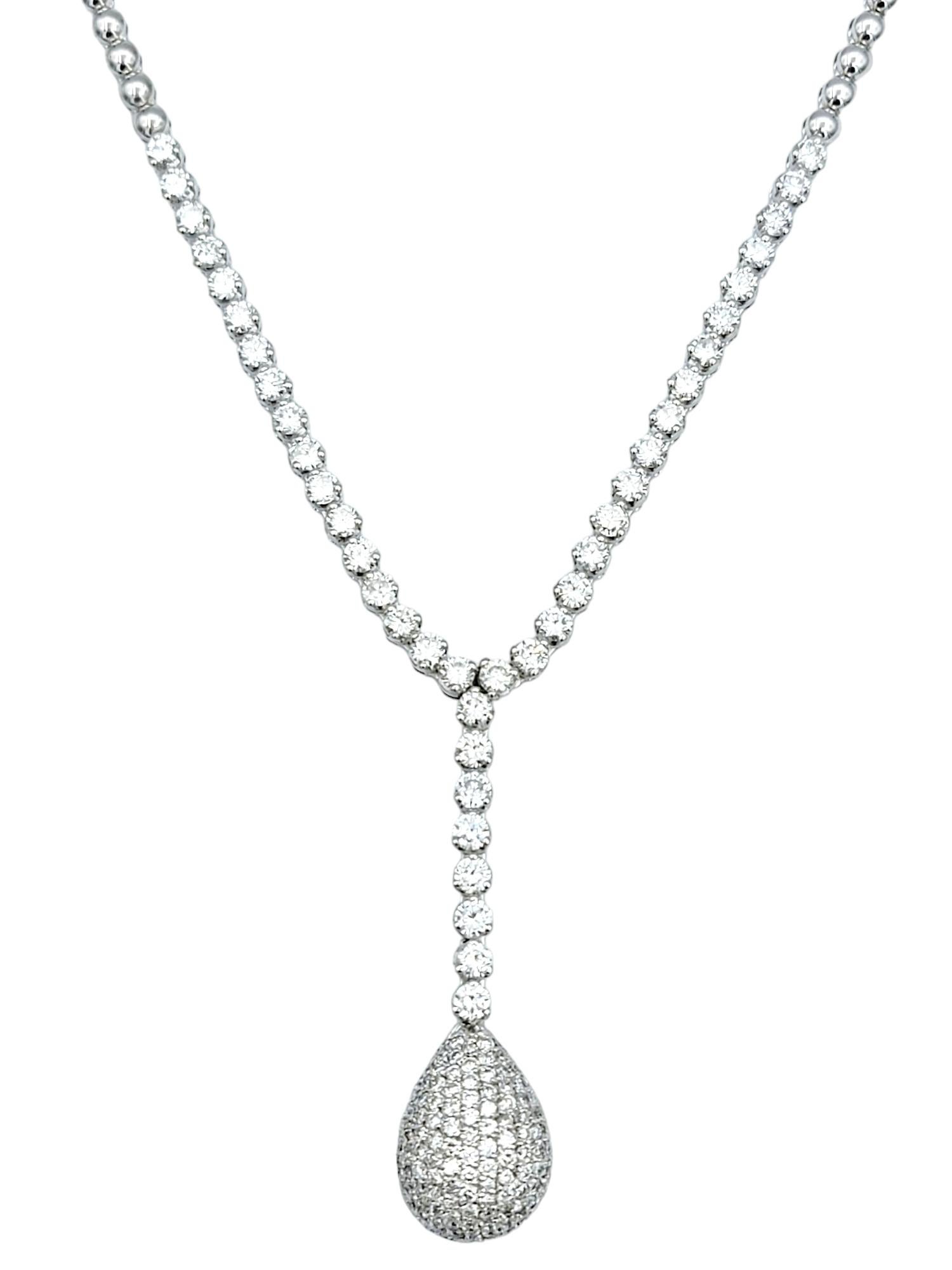 Elegance and sophistication converge in this breathtaking diamond lariat necklace, a dazzling adornment crafted with meticulous precision in 18 karat white gold. The focal point of the piece is the teardrop pendant, generously encrusted with pave