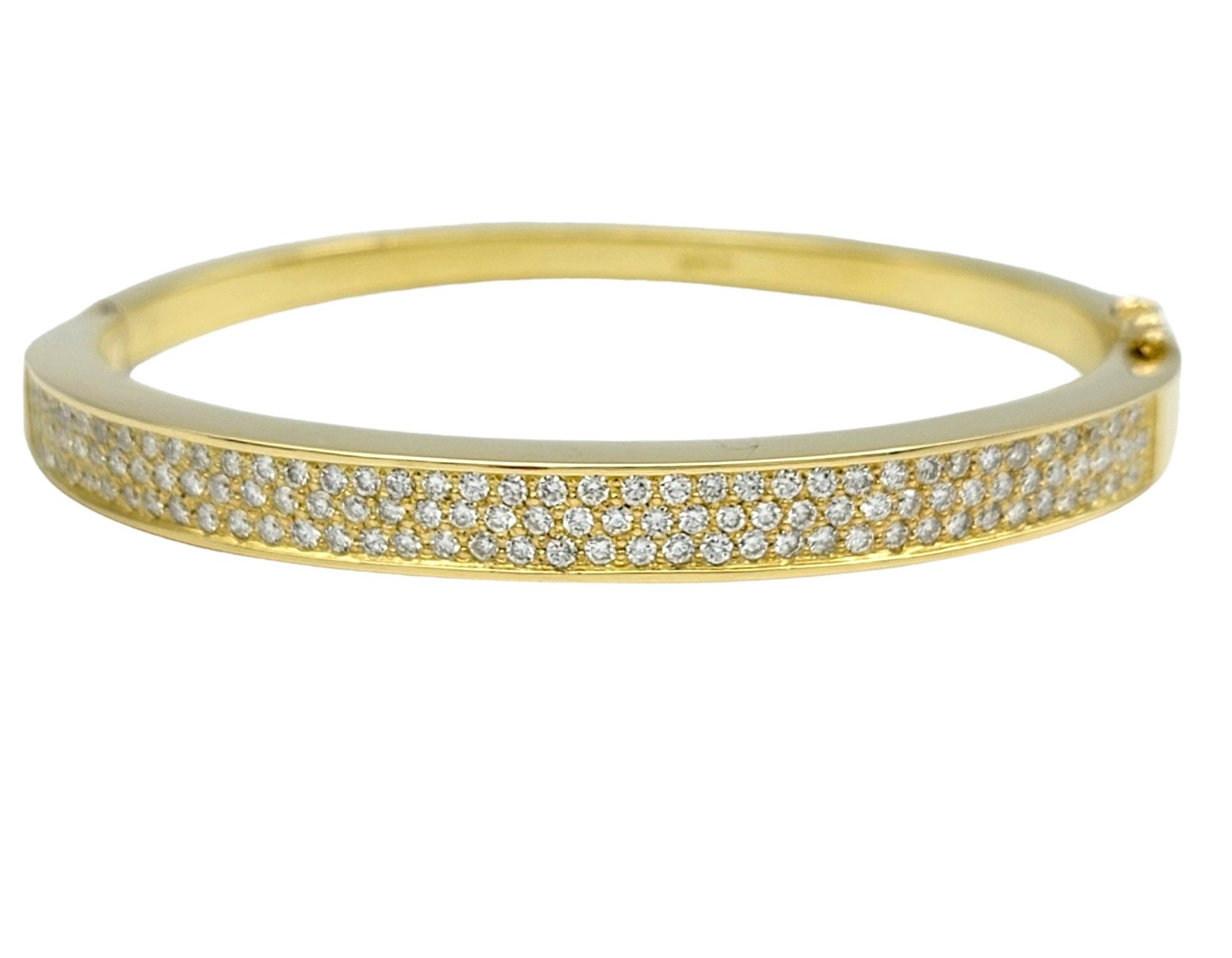 The inner circumference of this bracelet measures 6.38 inches and will comfortably fit up to a 6.25 inch wrist. 

This diamond pave hinged bangle bracelet exudes timeless elegance, crafted in lustrous 18 karat yellow gold. Adorned with a sparkling