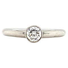Round brilliant solitaire engagement ring bezel platinum