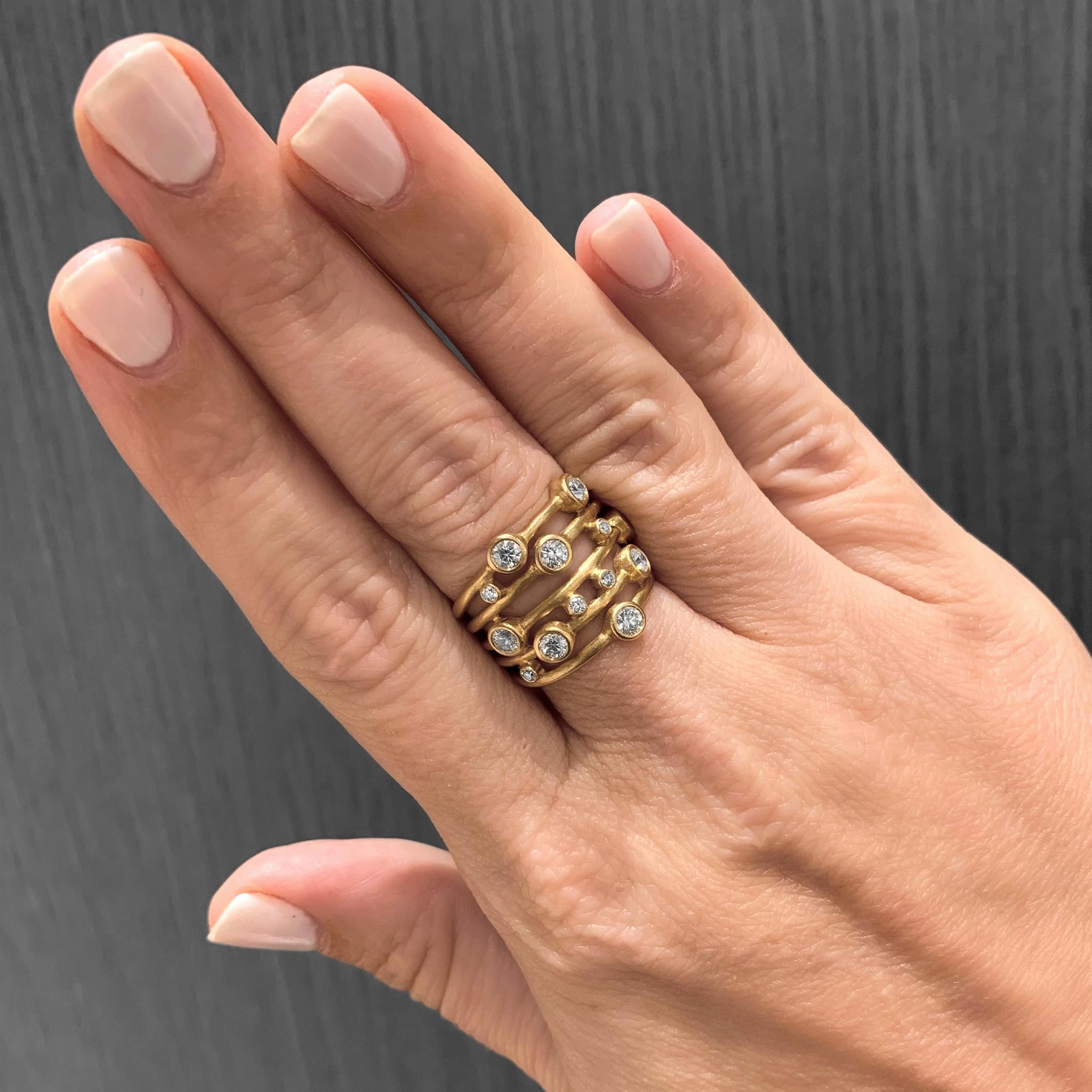 Bubble Wrap Ring hand-fabricated in Denmark by Wille Jewellery in satin-finished 18k yellow gold showcasing thirteen round brilliant-cut white diamonds totaling 0.80 carats, individually bezel-set and scattered across five solid gold bands. Stamped