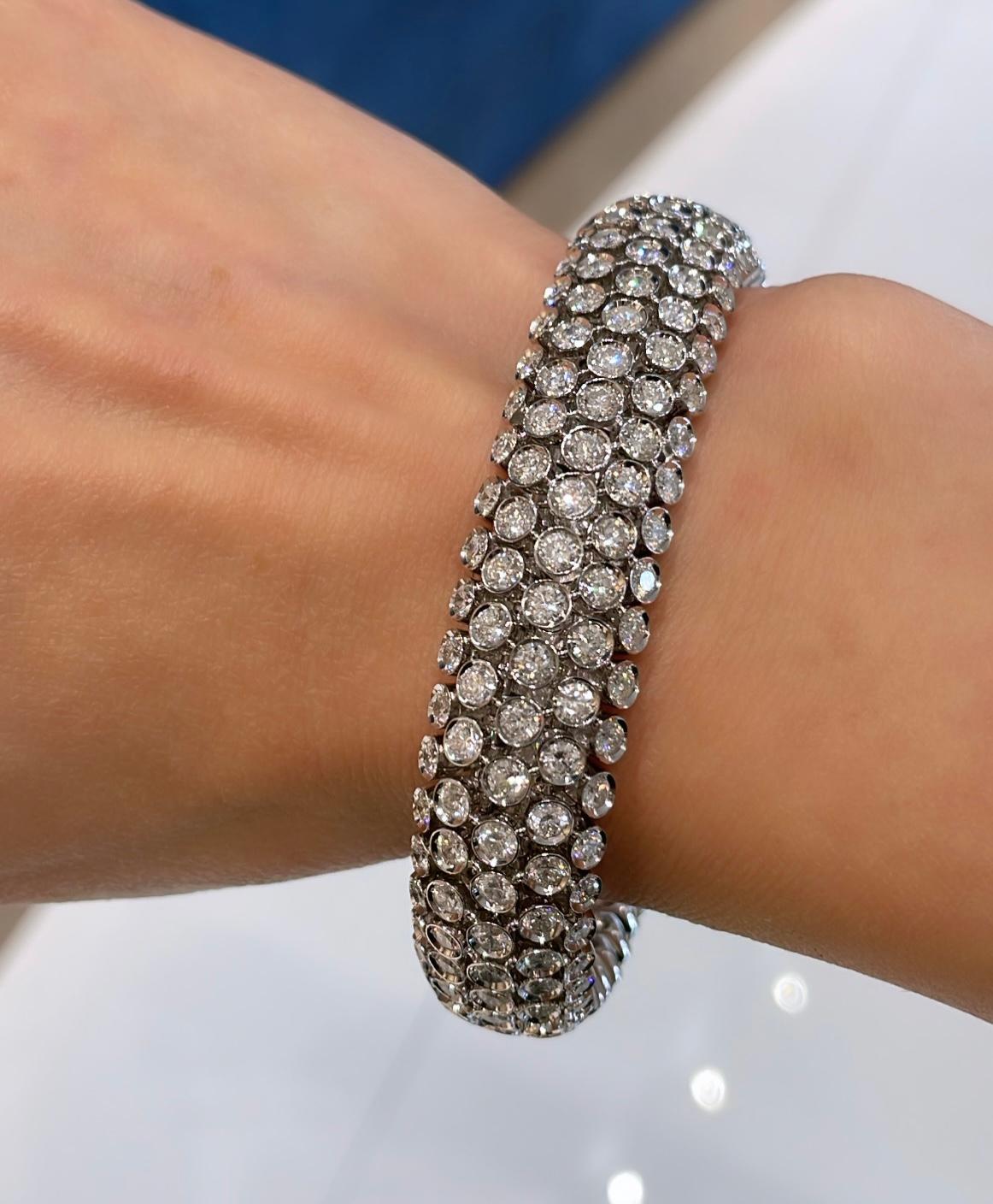 This stunning 18K white gold bangle has 276 round brilliant diamonds totaling 14 carats. This bangle is perfect for a night out or a special event. It is a true showstopper that will make a statement!
It can be worn in both directions as shown in