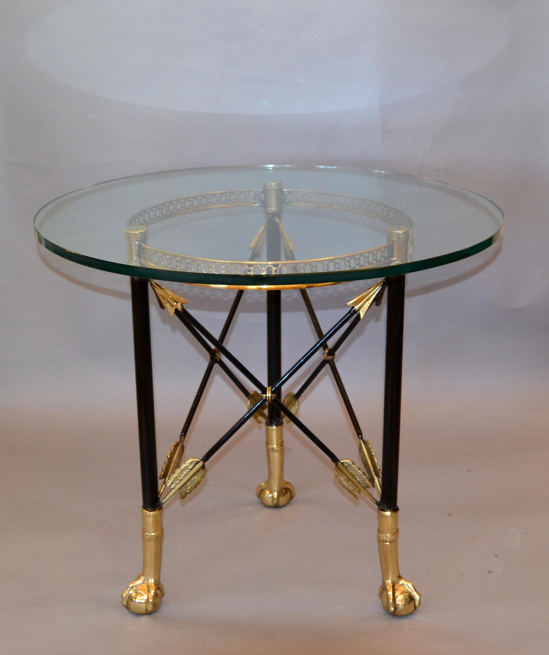 Round Hollywood Regency bronze and glass top side or cocktail table.
Please pay attention to the very detailed design of the crossed arrows and the ball and claw feet.
This Table is ready for a new Home.