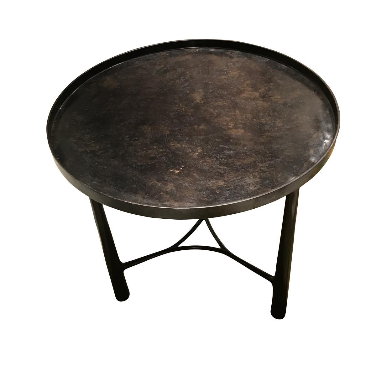 Contemporary German three-cone shaped bronze tripod legs, round top side table.
Mottled bronze top with lip.

 
  
 