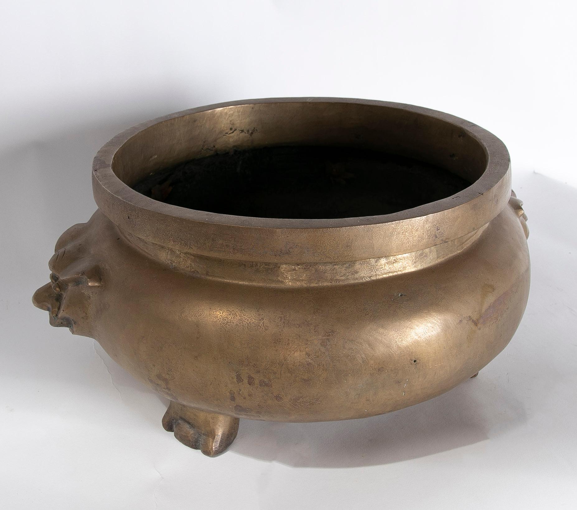 Asian Round Bronze Vessel with Two-Sided Decoration and Foot-Shaped Feet For Sale