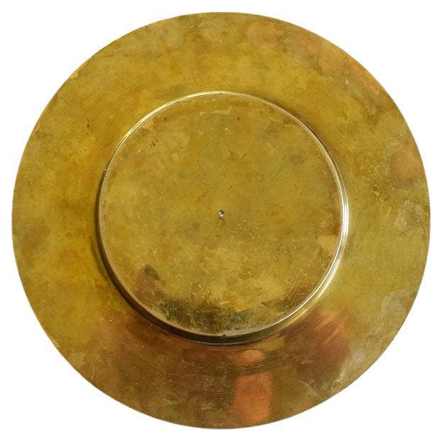A round brutalist style brass ashtray encrusted with brown oval wood pieces around the edges. This would be a great piece to use to accent your other mid-century barware, or as a catchall or trinket dish. Marked at bottom Made In India