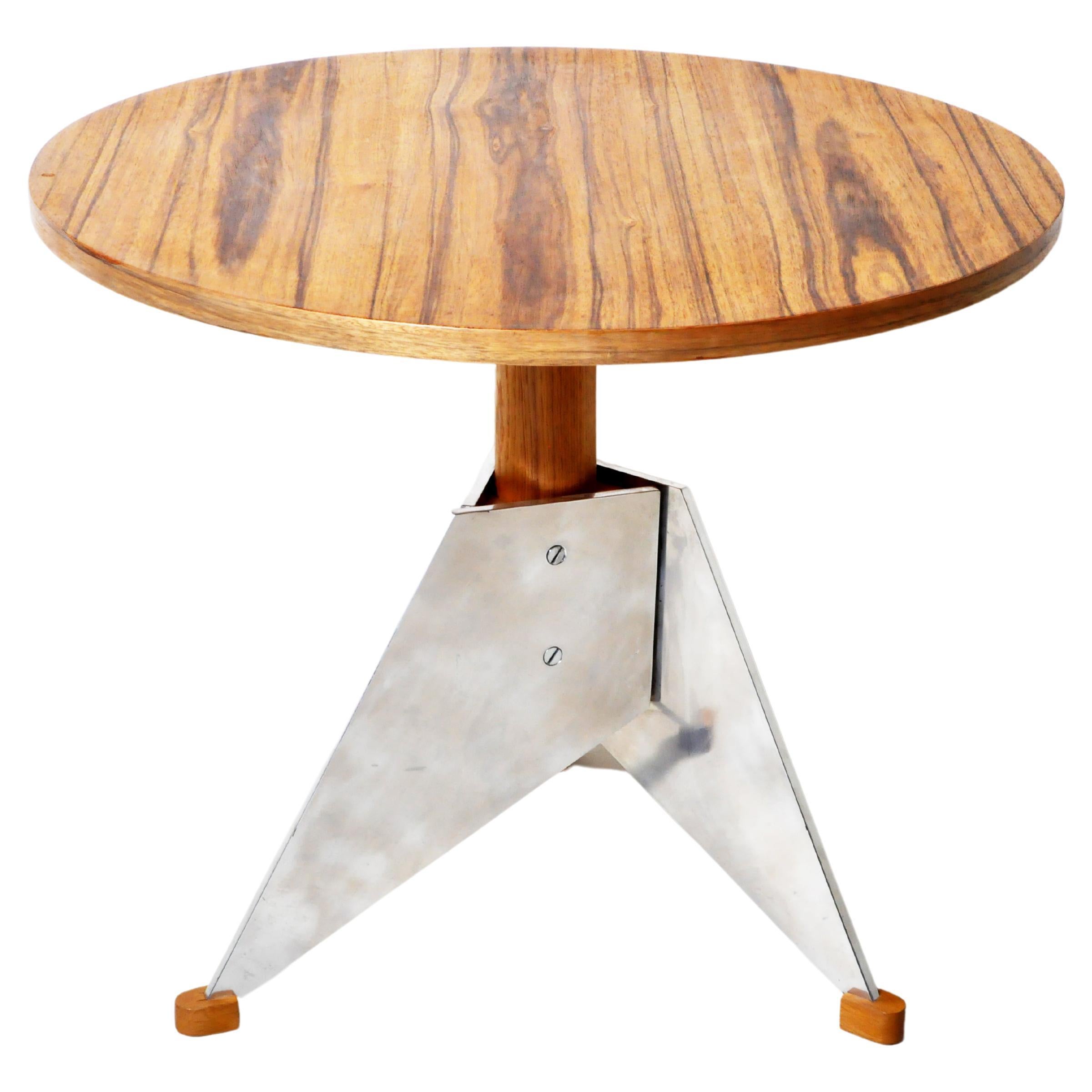 A brutalist sculptural side table with a thick glass top attributed to