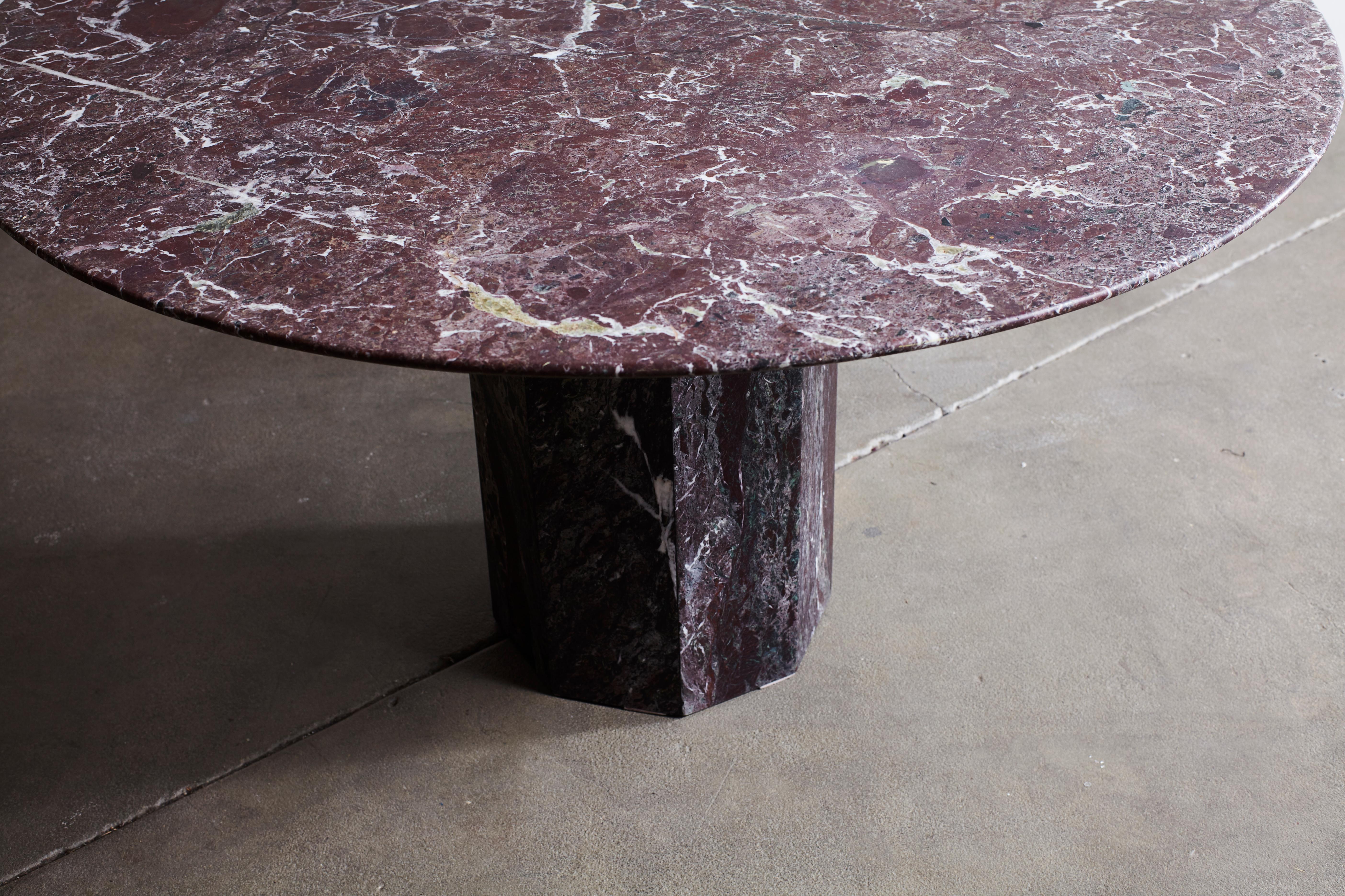 Round burgundy honed marble with beautiful faceted pedestal table.