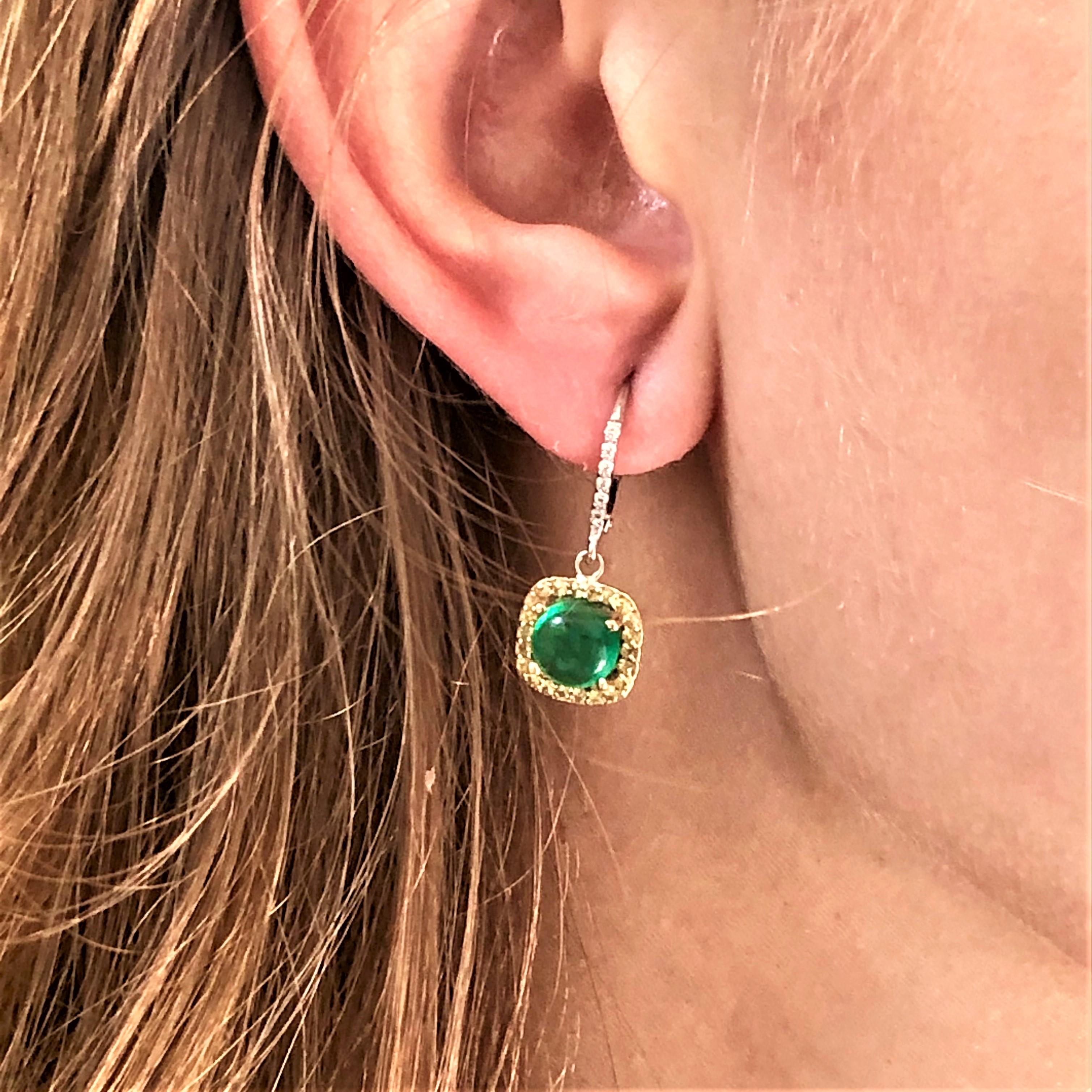 Fourteen karat white gold drop hoop earrings with cabochon emerald, yellow sapphire and diamonds
Round shape cabochon emerald weighing 3.40 carat 
Diamond weighing 0.20 carat 
Yellow Sapphire weighing 0.35 carat 
Earrings measuring 1.5 inch long