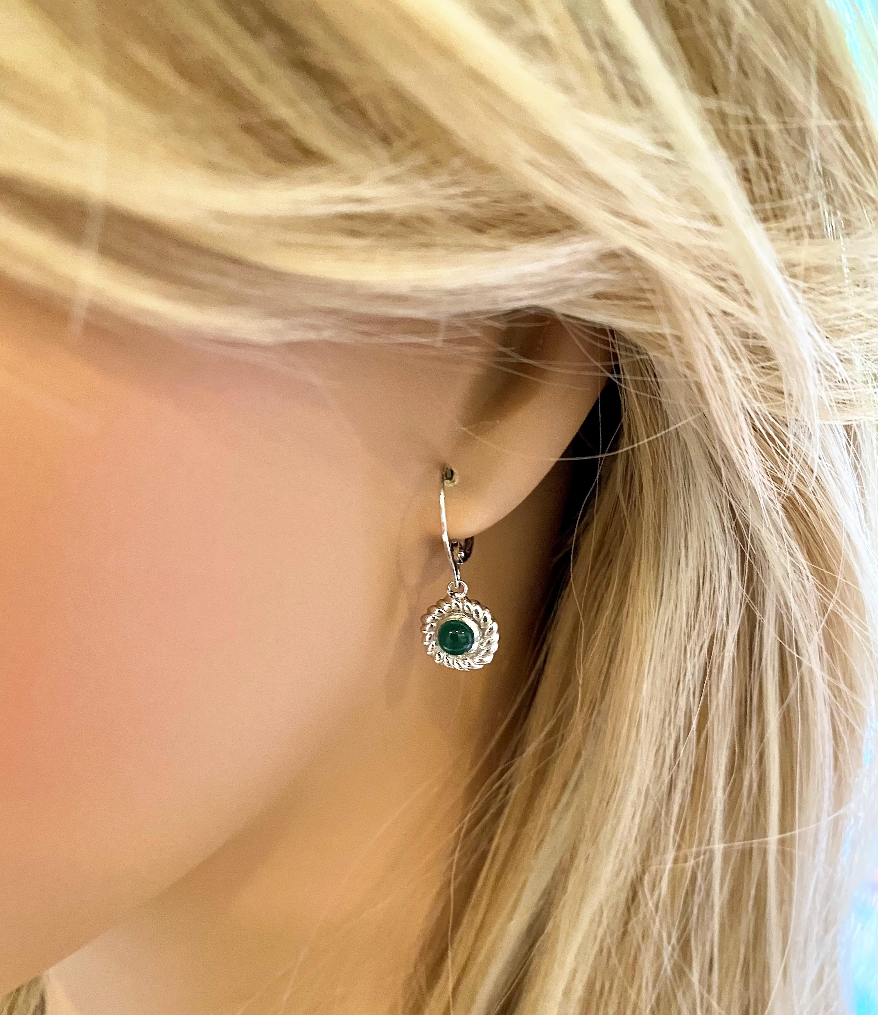 14 karats white gold braided bezel set cabochon emerald lever back earrings
Cabochon emeralds weighing 1.70 carat
Emeralds measuring 4.5 millimeters
Emerald hue tone color is of grass green
Earrings are hanging of a white gold lever backs
Handmade