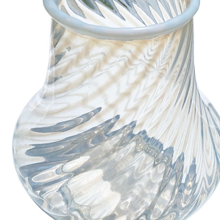 A small round opalescent white candy cane stripe Hobbs vase. With a translucent body, soft white stripes are decorated diagonally across the body of the glass. The neck is milky white and more narrow than the body. 

Dimensions:
Neck 3.25