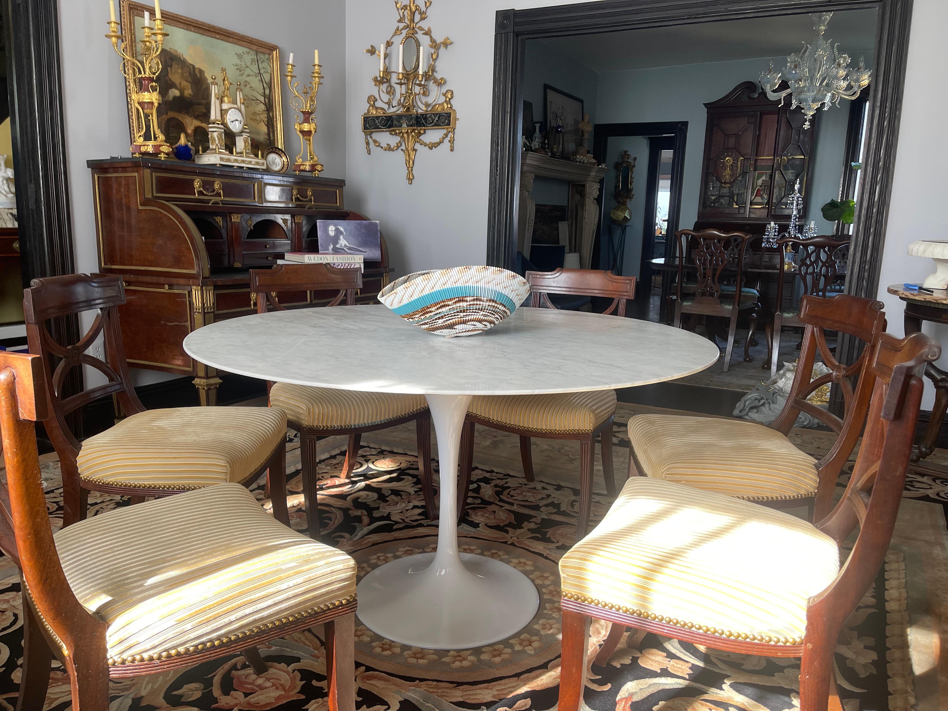 We are offering this 51” diameter Carrara marble top dining table. 
It was authentically created using the same quality standards and materials as Knoll’s 1960’s original, except this is in much better condition as most from that era. 
It will seat