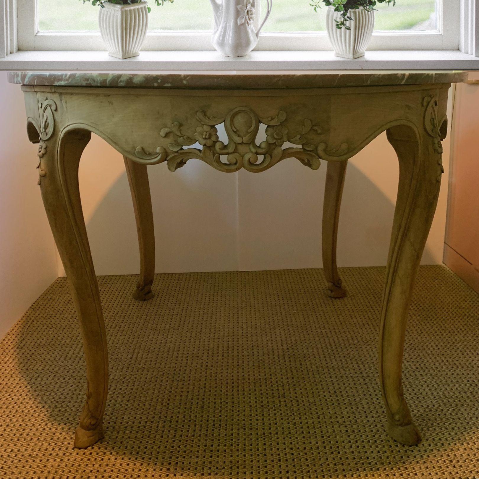 Decorate an entry or hallway with this antique circular side table. Crafted in France circa 1920, the base is built of bleached oak that gives the piece a casual, wabi-sabi flair to a traditionally French style. The classic desk exemplifies the