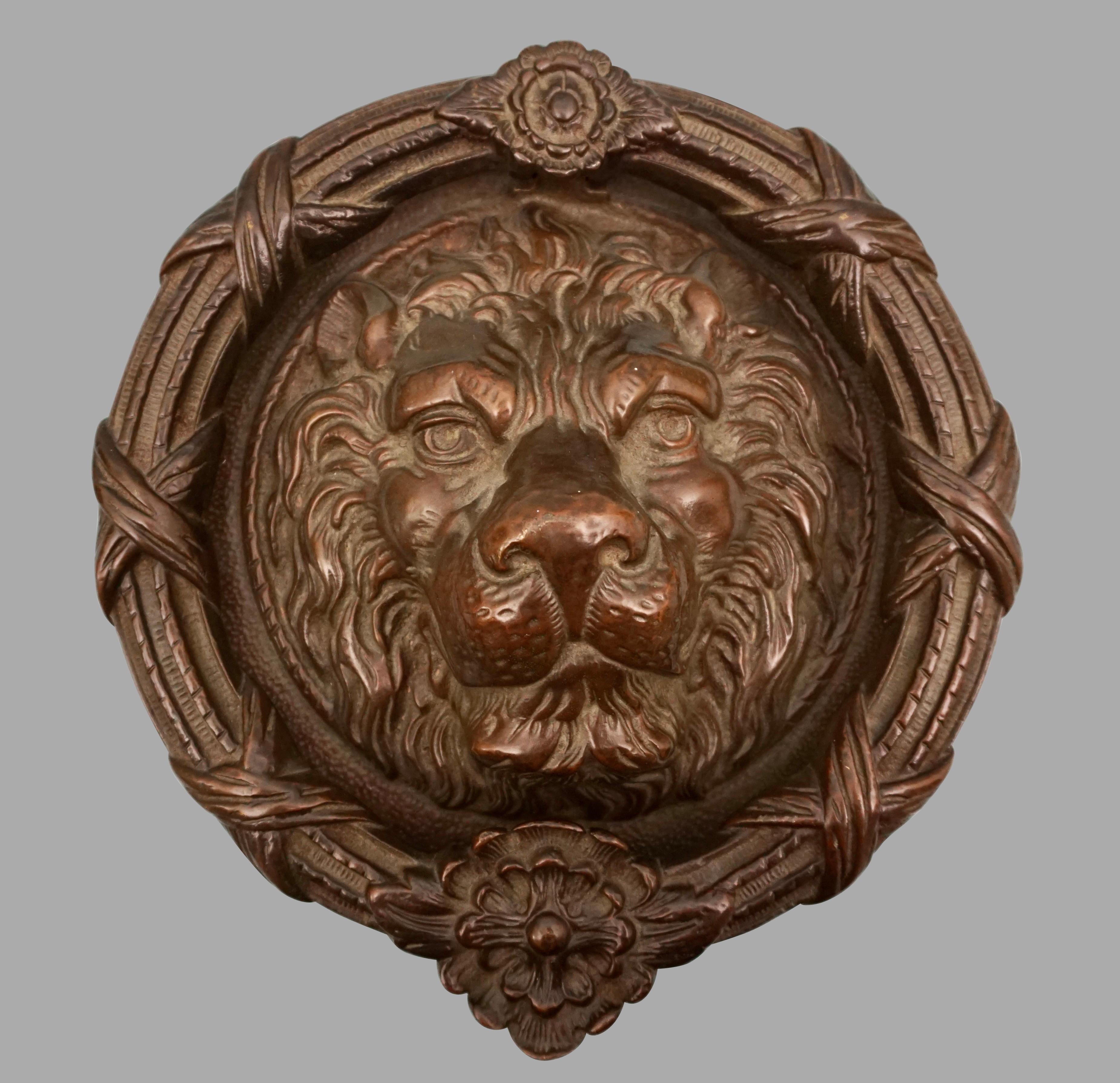 A high quality solid bronze door knocker in the form of a lion's face. This handsome and large piece is in the neoclassical taste and is impressive both in scale and quality of execution. Probably English in origin, this knocker certainly makes a