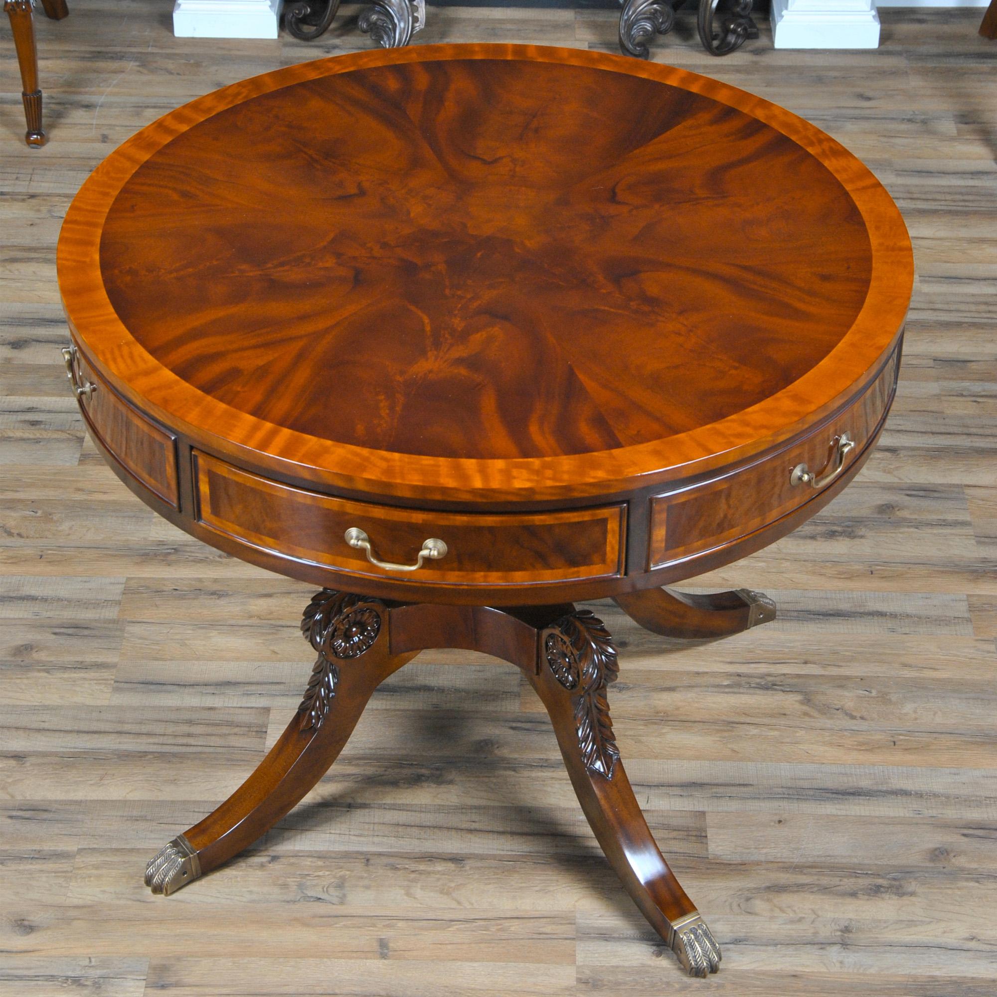 Our most robust drum table this large Round Center Table has eye catching appeal with satin wood banding, carved knees and a thick top with three dovetailed drawers. Superb quality mahogany solids and mahogany and satinwood veneers combine to create