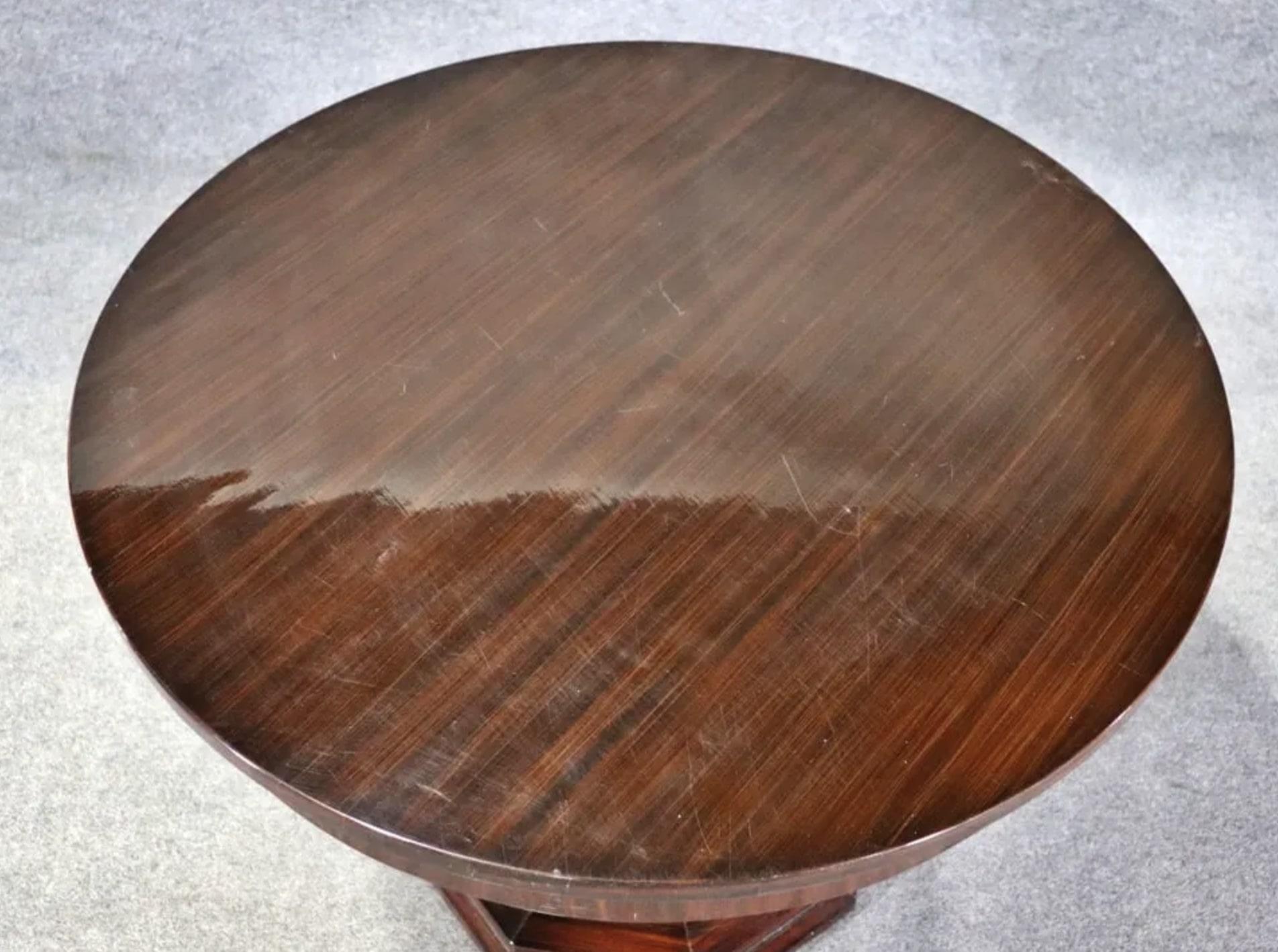 Round art deco inspired center table in deep mahogany grain. 
Please confirm location NY or NJ