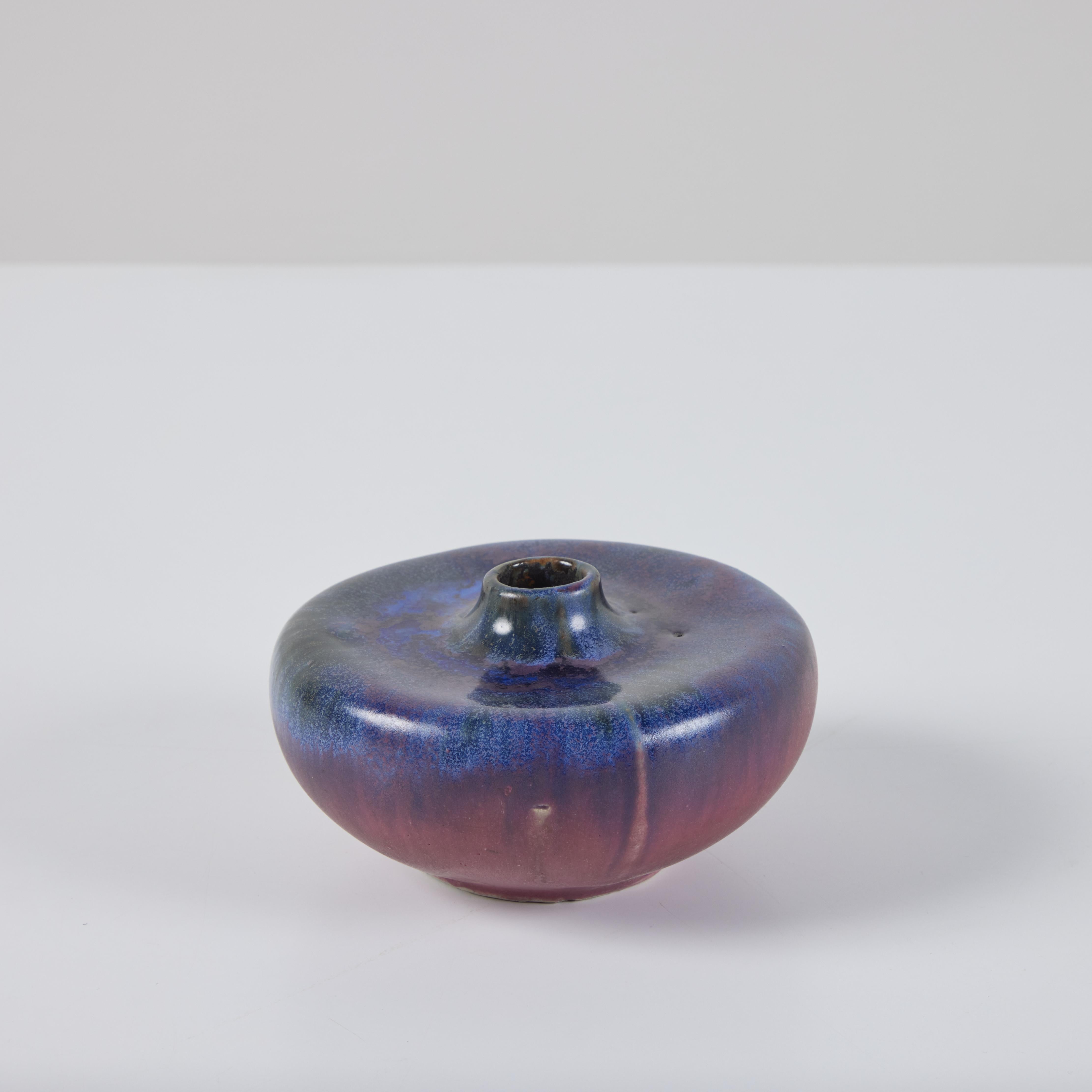 Weed pot finished in a multi-tonal purple drip glaze, accented with blue yellow glaze. The middle portion of the weed pot has the deep purple glaze bleeding into the lighter purple glaze below. Artist label imprinted on underside.

Dimensions
6.5”