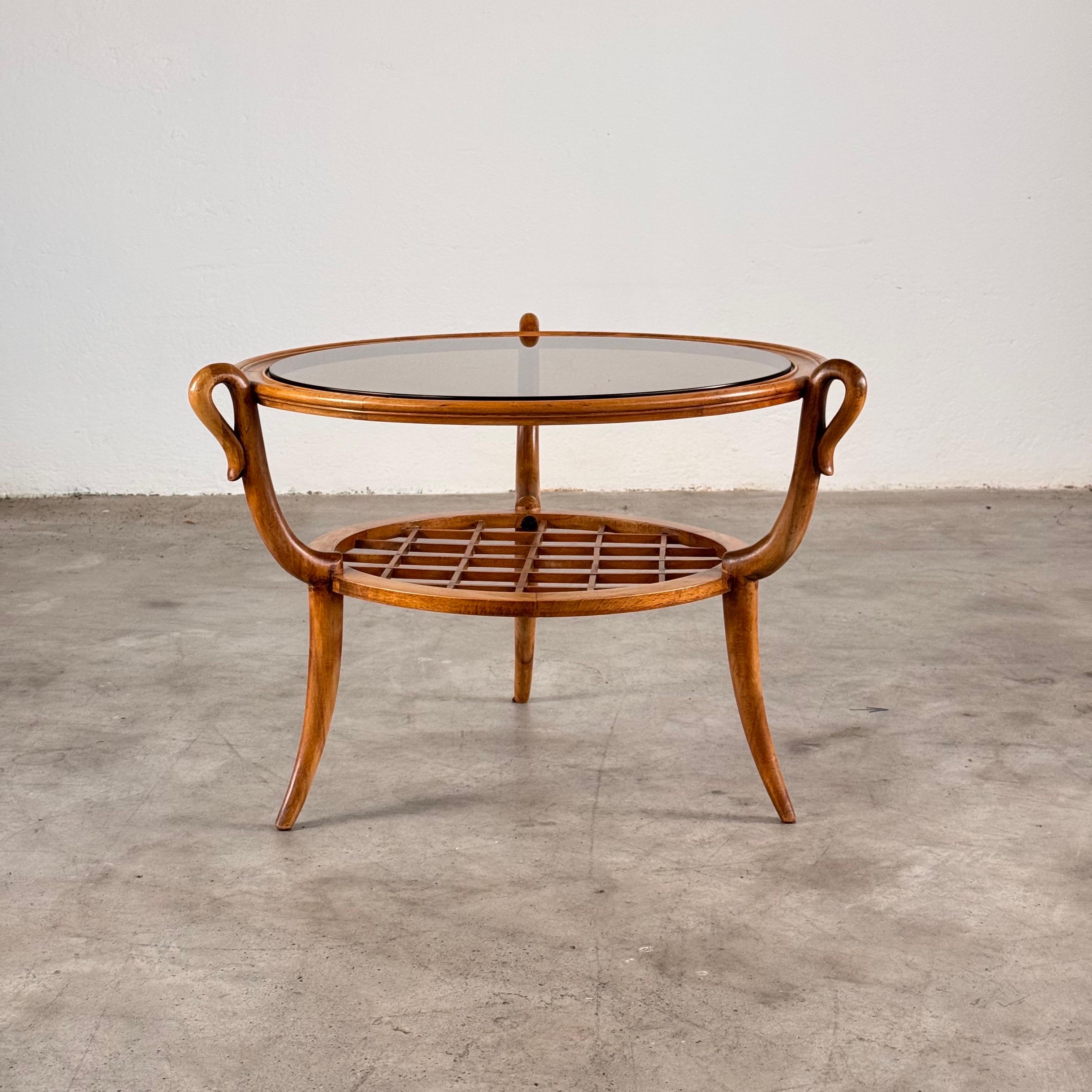 An elegant and sculptural coffee table attributed to Paolo Buffa and produced by Arrighi Serafino in Cantù in the 1950s. Crafted in solid cherry wood, the piece combines refined proportions with the artisanal sophistication of Italian mid-century