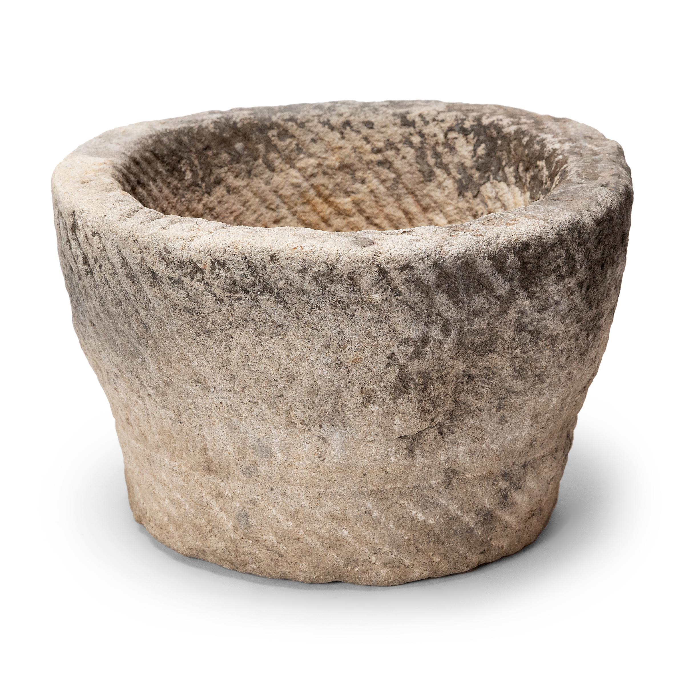 Once used on a provincial Chinese farm to hold water or animal feed, this early 20th-century stone trough is celebrated today for its organic form and rustic authenticity. Hand-carved from solid limestone, the trough has a circular form with slight