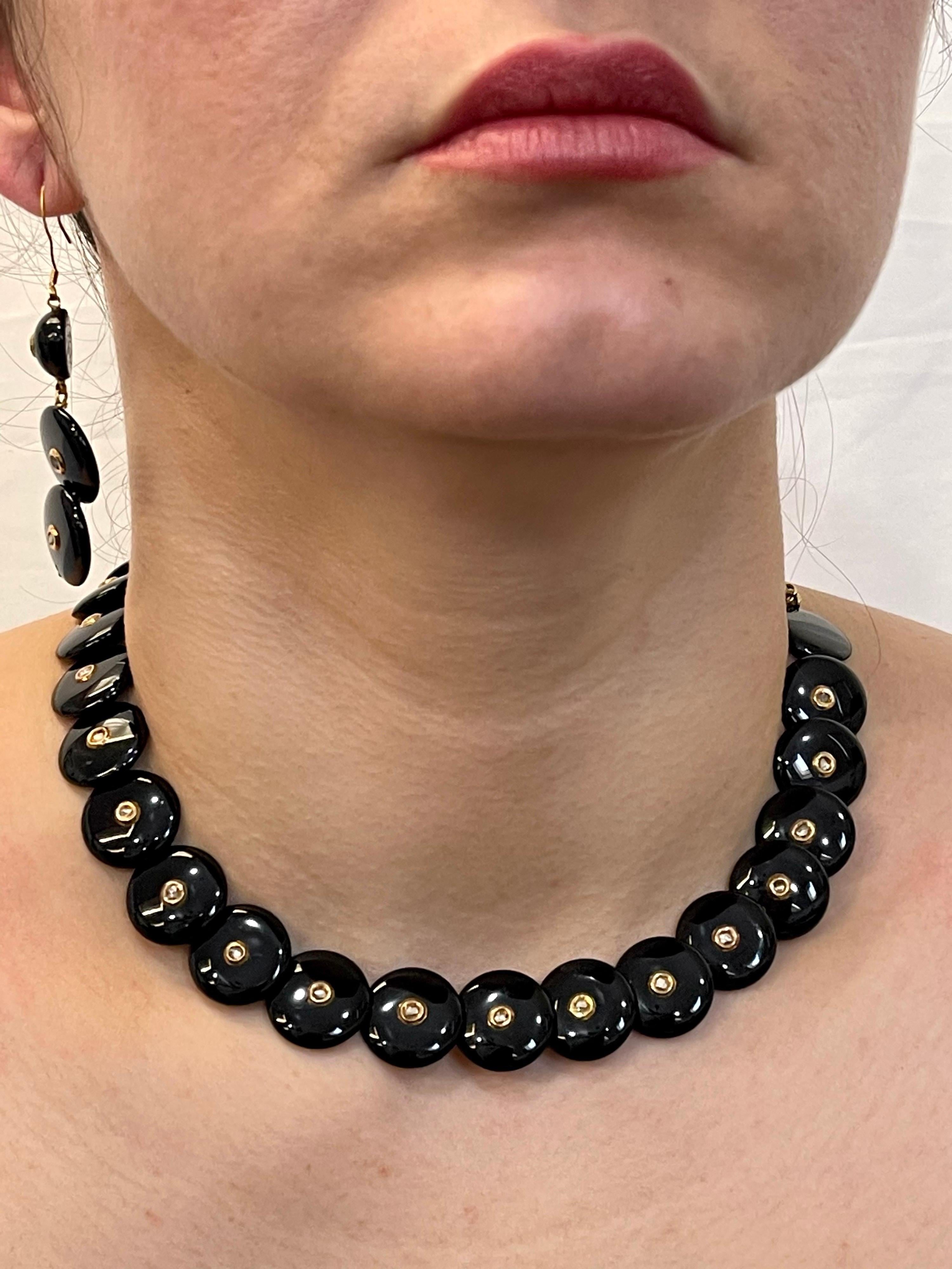 Round Circle Black Onyx With Rose cut Diamond 18 K Yellow Gold Necklace, Earring
Black Ony round circles of 1.5 CM radius are attached in a row .Each circle has a tiny rose cut diamond set in 18 Karat yellow gold .
Comes with matching Fish hook