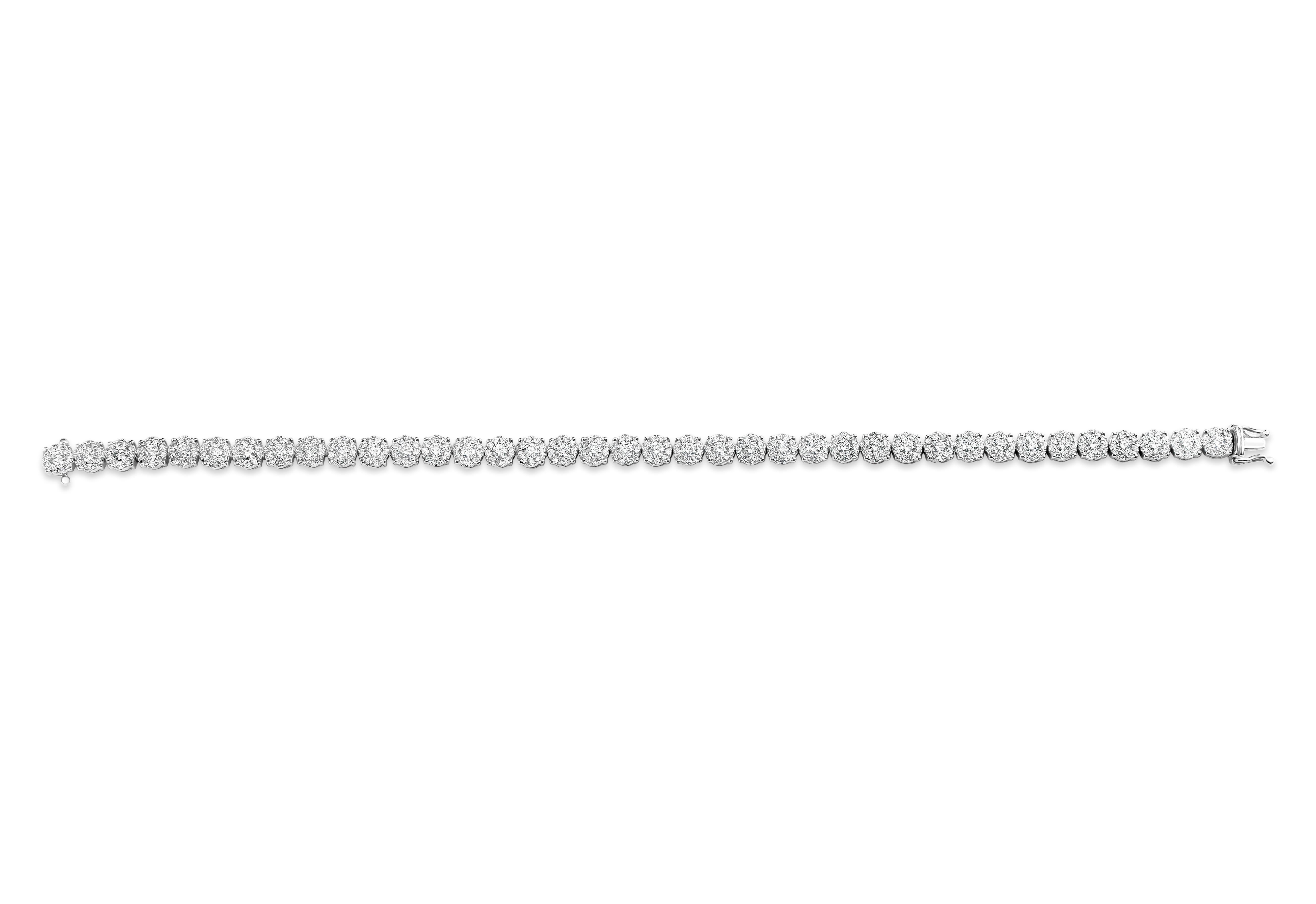 Brilliant tennis bracelet showcasing clusters of round diamonds set in a single row. Diamonds weigh 3.46 carats total. Made in 18 karat white gold.

