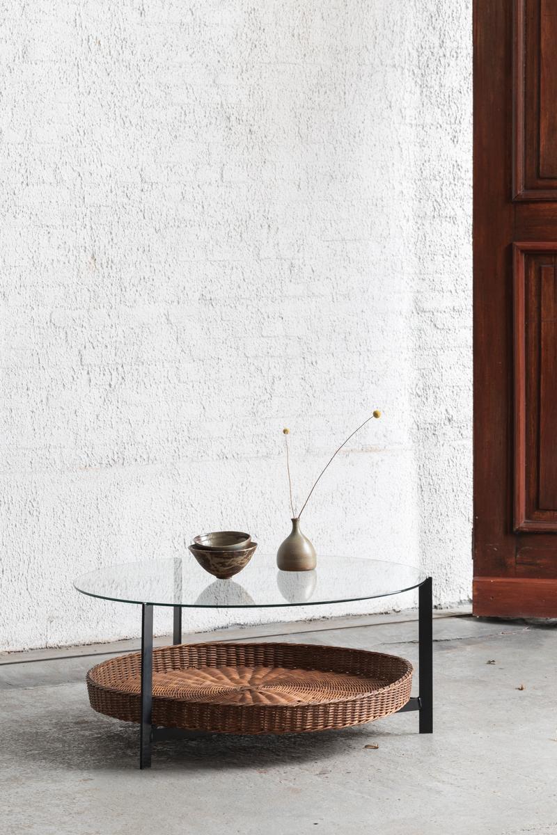Round coffee table with magazine holder designed by Rudolf Wolf and produced by Rohé Noordwolde in the Netherland in the 1950s. Made of a metal frame with a rattan magazine basket and finished with a glass top. In decent condition with some