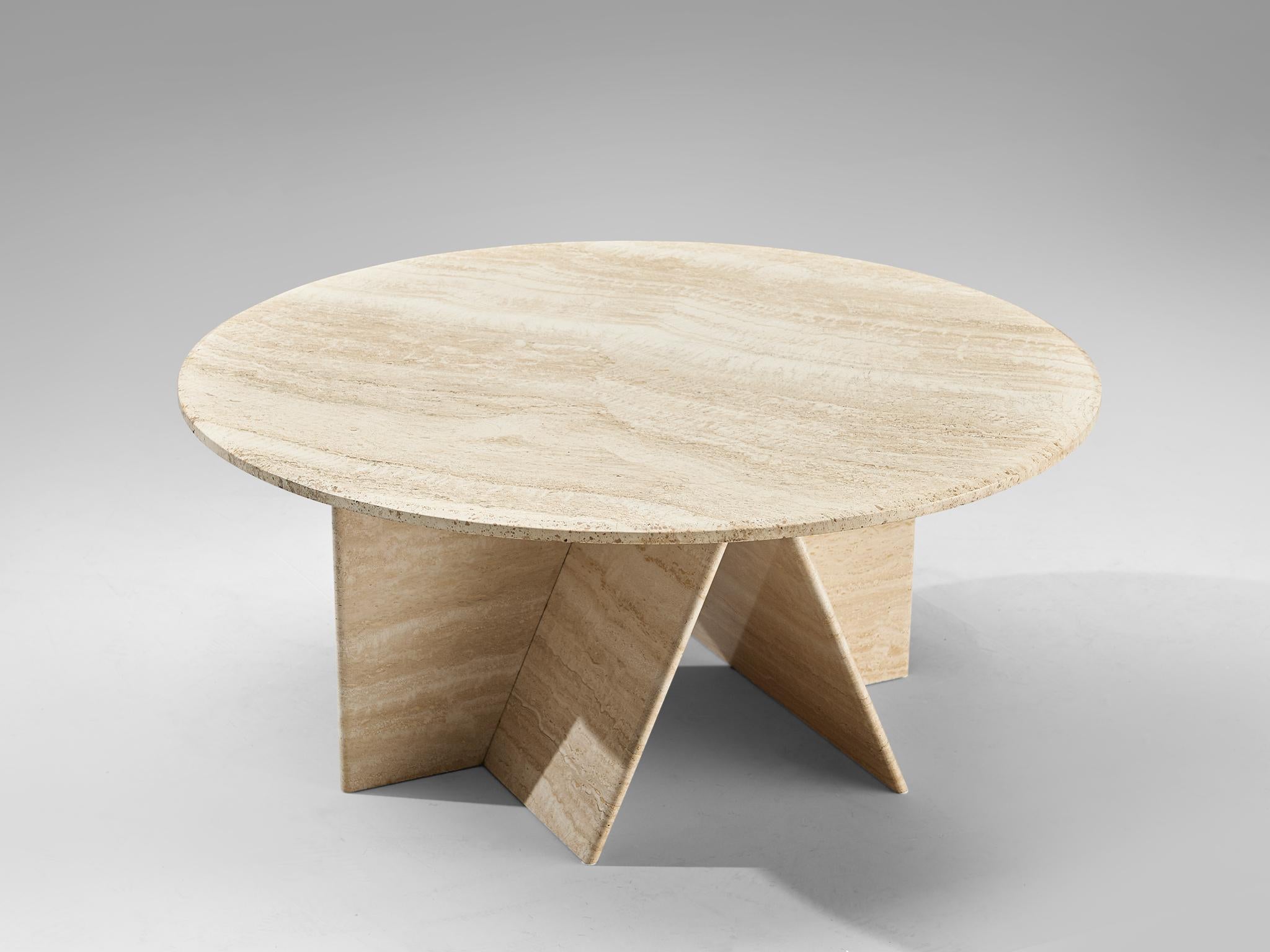 Round coffee table, travertine, Italy, 1970s

This coffee table is fully made out of bright travertine which gives it a sculptural look. The natural lines of the limestone structure the surface. The round tabletop lays on a geometric base with two
