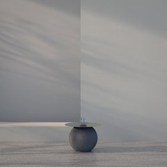 Round coffee table, stainless steel and volcanic stone