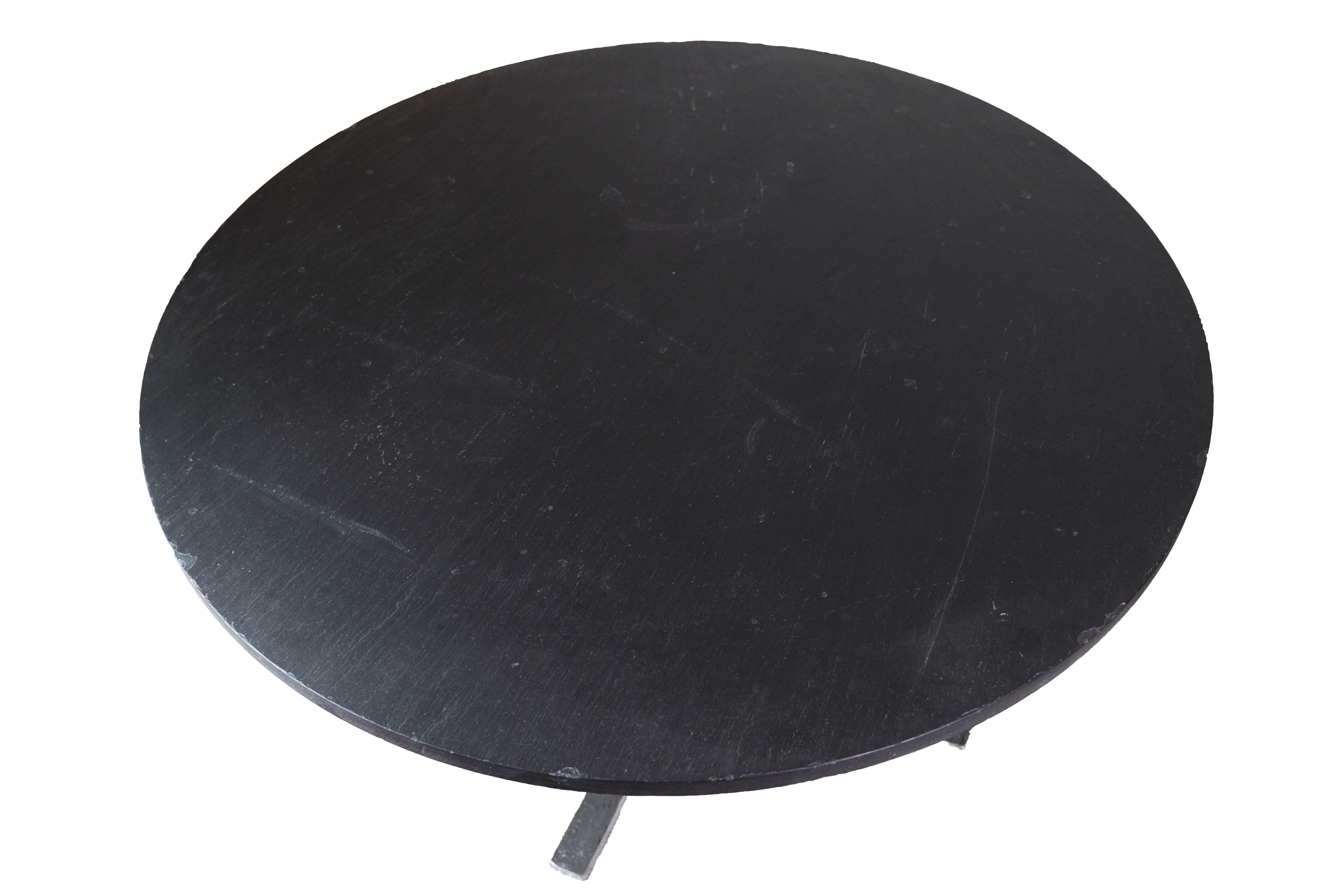 
This round coffee table with a black slate plate, designed by Sigurd Ressell Falcon in the 1960s, is a striking piece that encapsulates the essence of mid-century modern design.

Crafted with clean lines and minimalist aesthetics, this table exudes