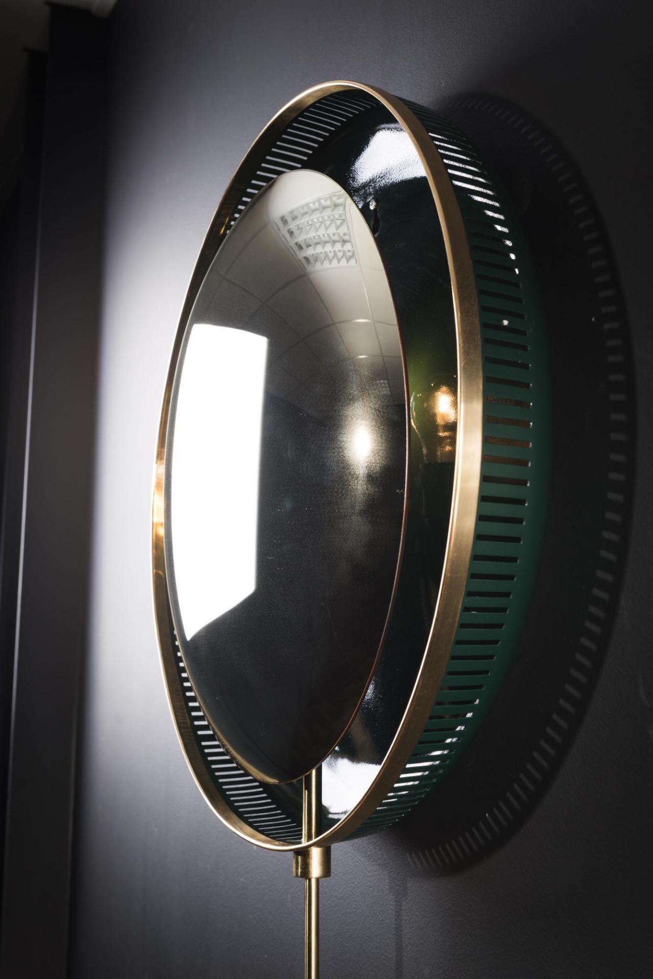 Round convex wall mounted and backlit mirror gold patina and midcentury style.