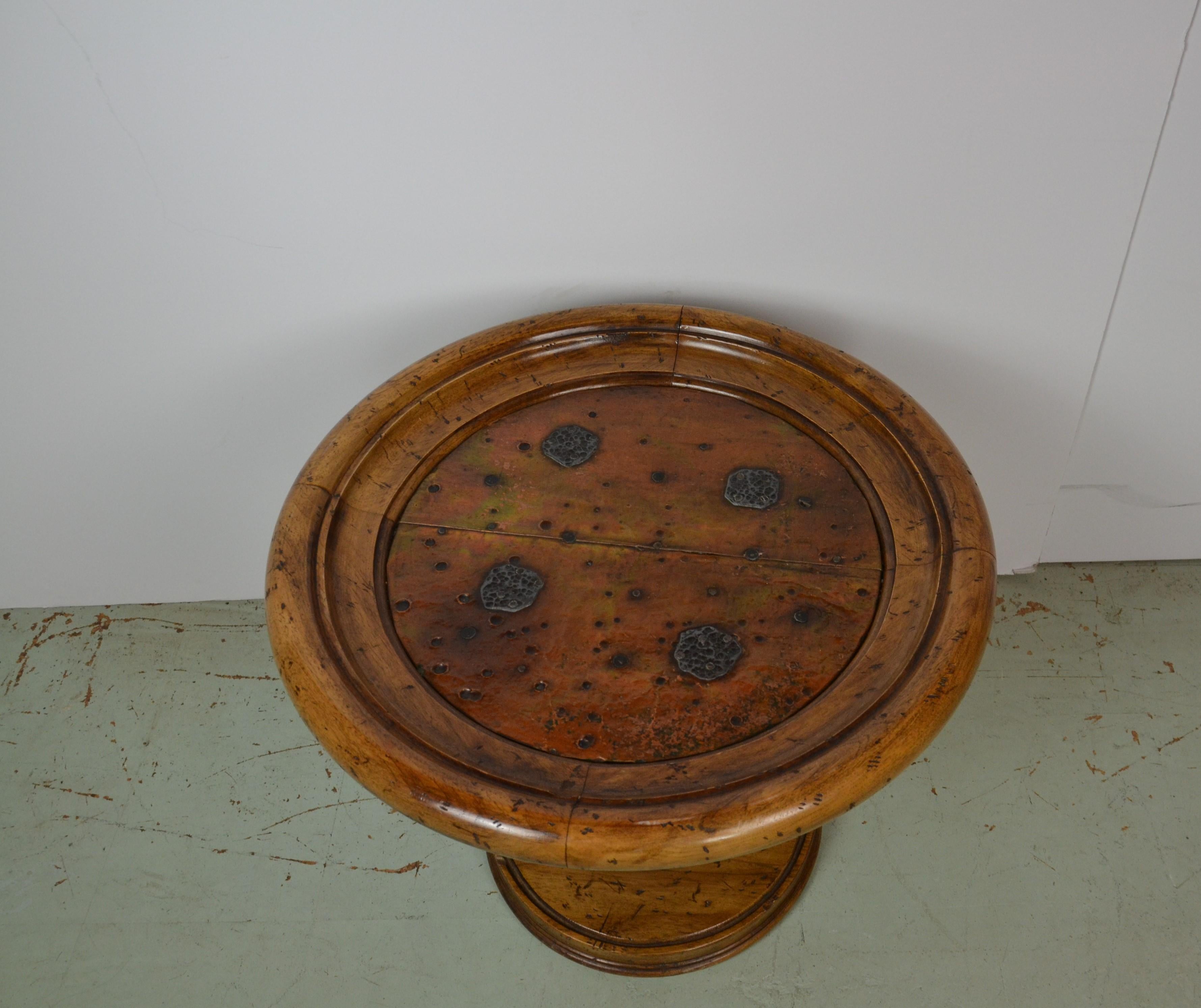 An oak side / end table with hammered copper top. Decorative medallions to the copper top. Platform base.