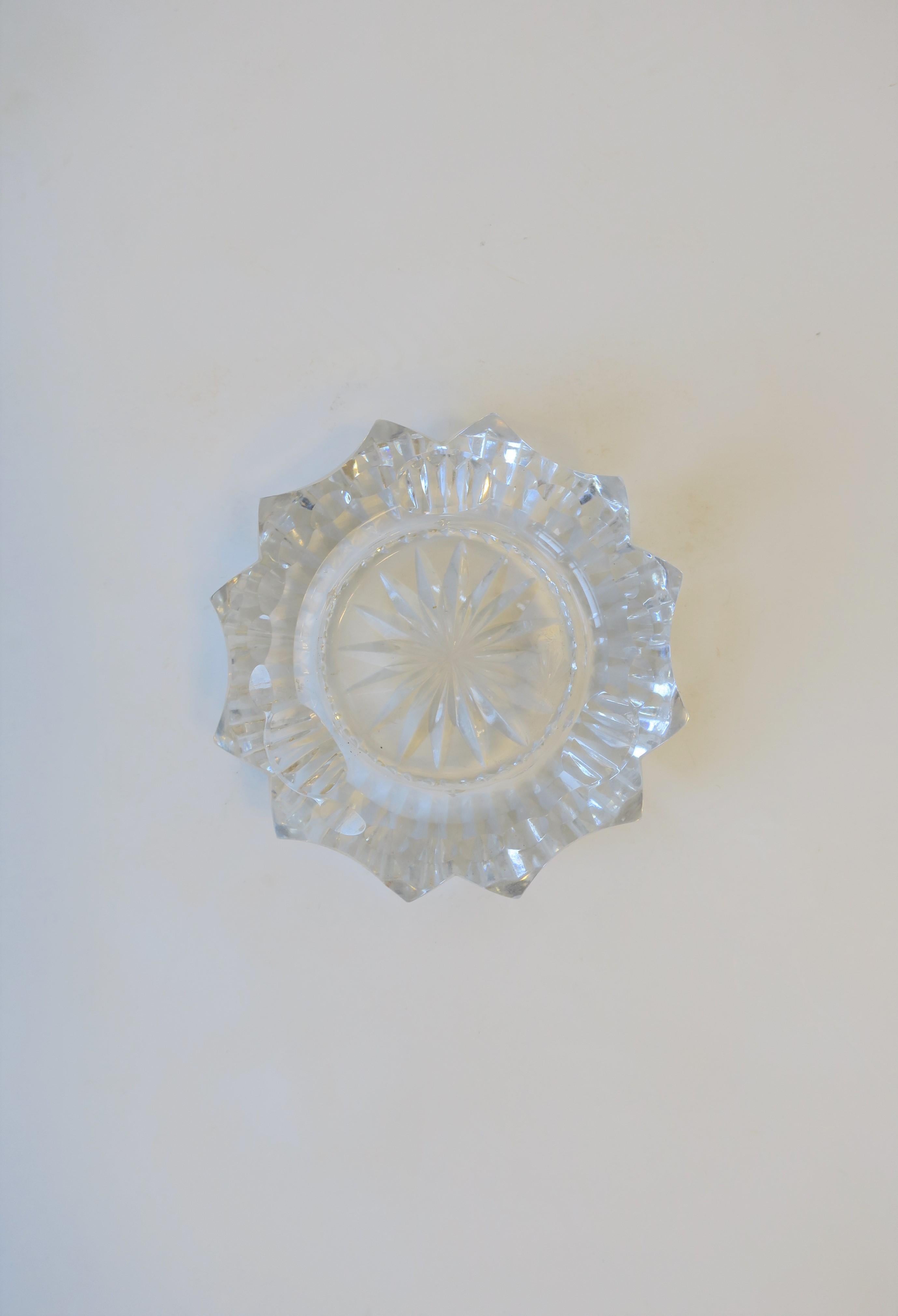 A beautiful round starburst-like cut crystal ashtray or jewelry dish. Dimensions: 4.25