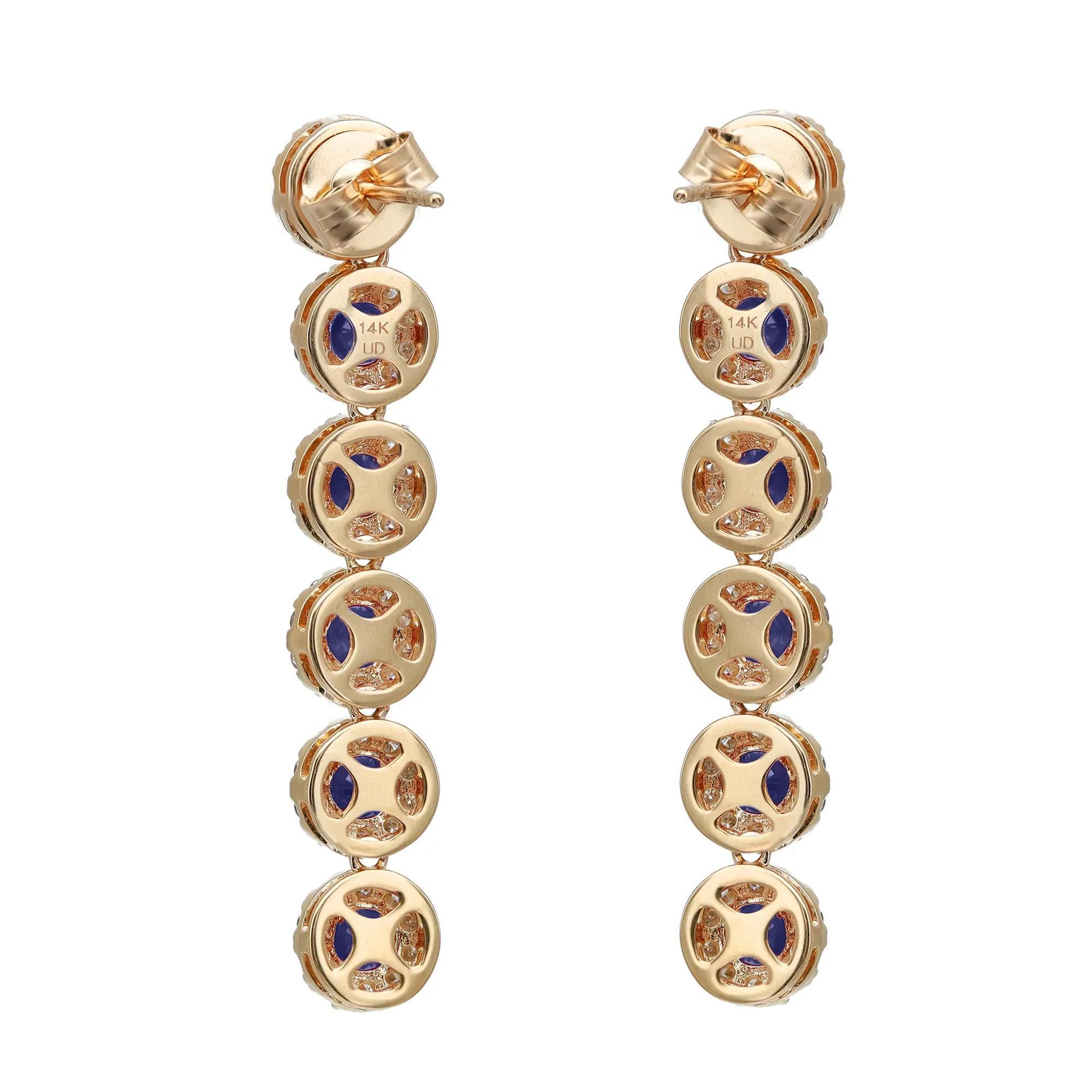 Elevate any attire with these dazzling drop earrings, perfect for any occasion. Crafted in fine 14K yellow gold. These earrings feature prong set round cut blue sapphires with a halo of round brilliant cut diamonds. Total blue sapphire weight: 3.00