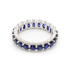 Round Cut Blue Sapphire Prong Set Diamond Eternity Band Ring in 18 K Gold White