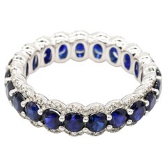 Round Cut Blue Sapphire Prong Set Diamond Eternity Band Ring in 18 K Gold White