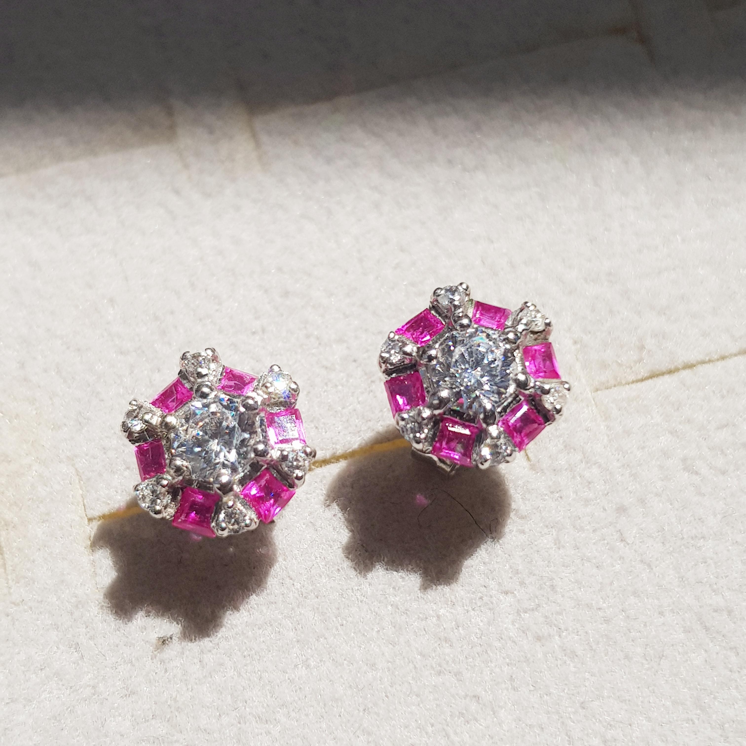 These stunning diamond and ruby earrings feature an Art Deco design, centered with a round cut diamond in a six-prong setting. The center is surrounded by six baguette cut rubies and six round diamonds. Signed spark!

Information
Style: Art