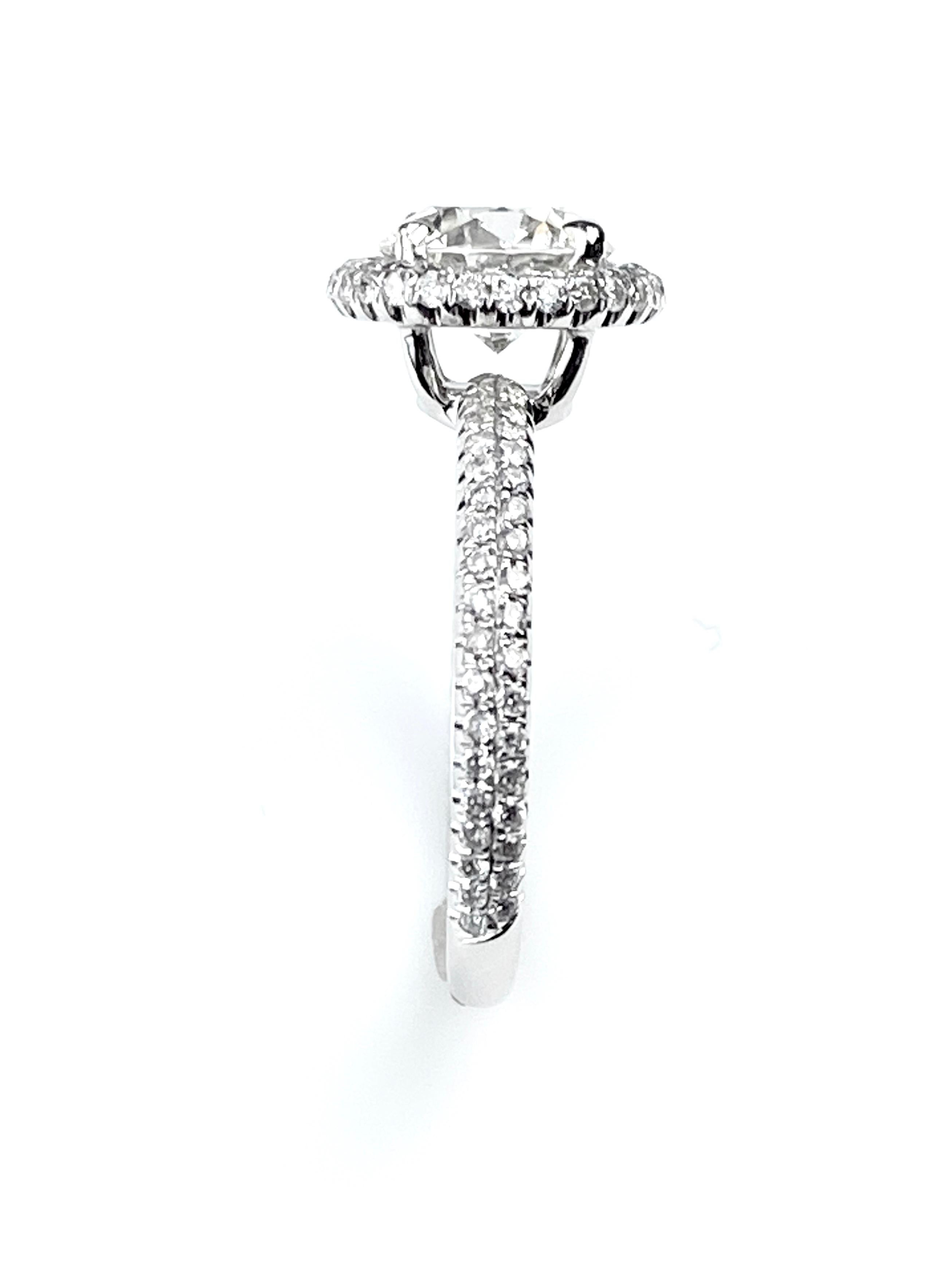 Contemporary Round Cut Diamond Engagement Ring with Pavé Halo and Shank in White Gold For Sale