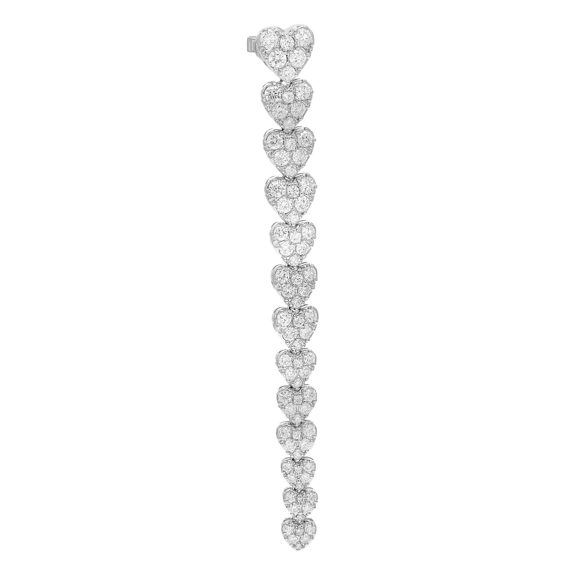 Showcasing these eye catchy multiple hearts long drop earrings, crafted in 18k white gold. These earrings feature 13 love hearts in graduation linked together to make a long drop earring. Encrusted with pave set round brilliant cut sparkling