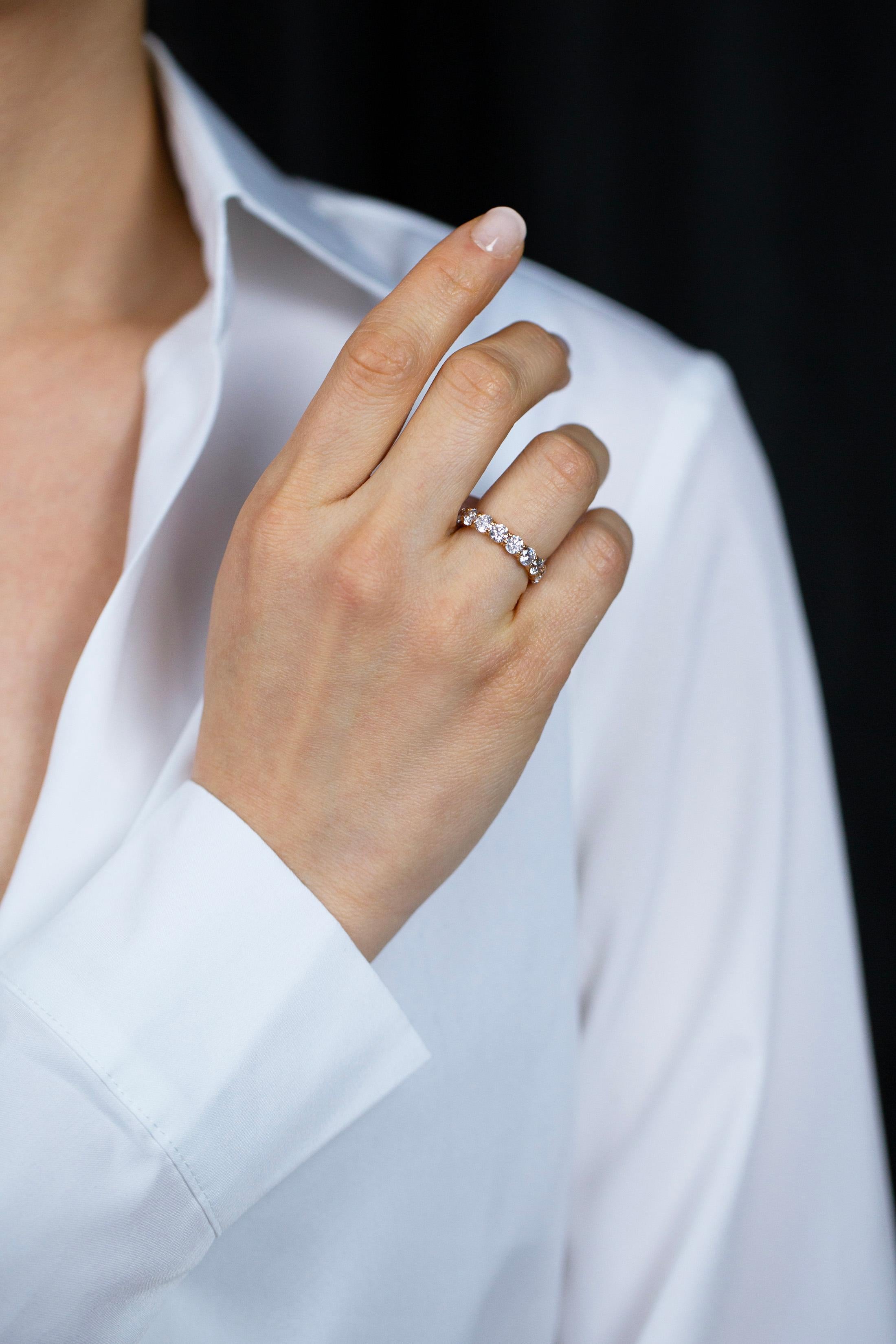 This gorgeous eternity wedding band showcasing 19 round brilliant diamonds weighing 3.80 carats total. Each diamond is approximately F color and SI in clarity. Set in a classic four prong basket setting and made in 18k rose gold. Size 6 US resizable