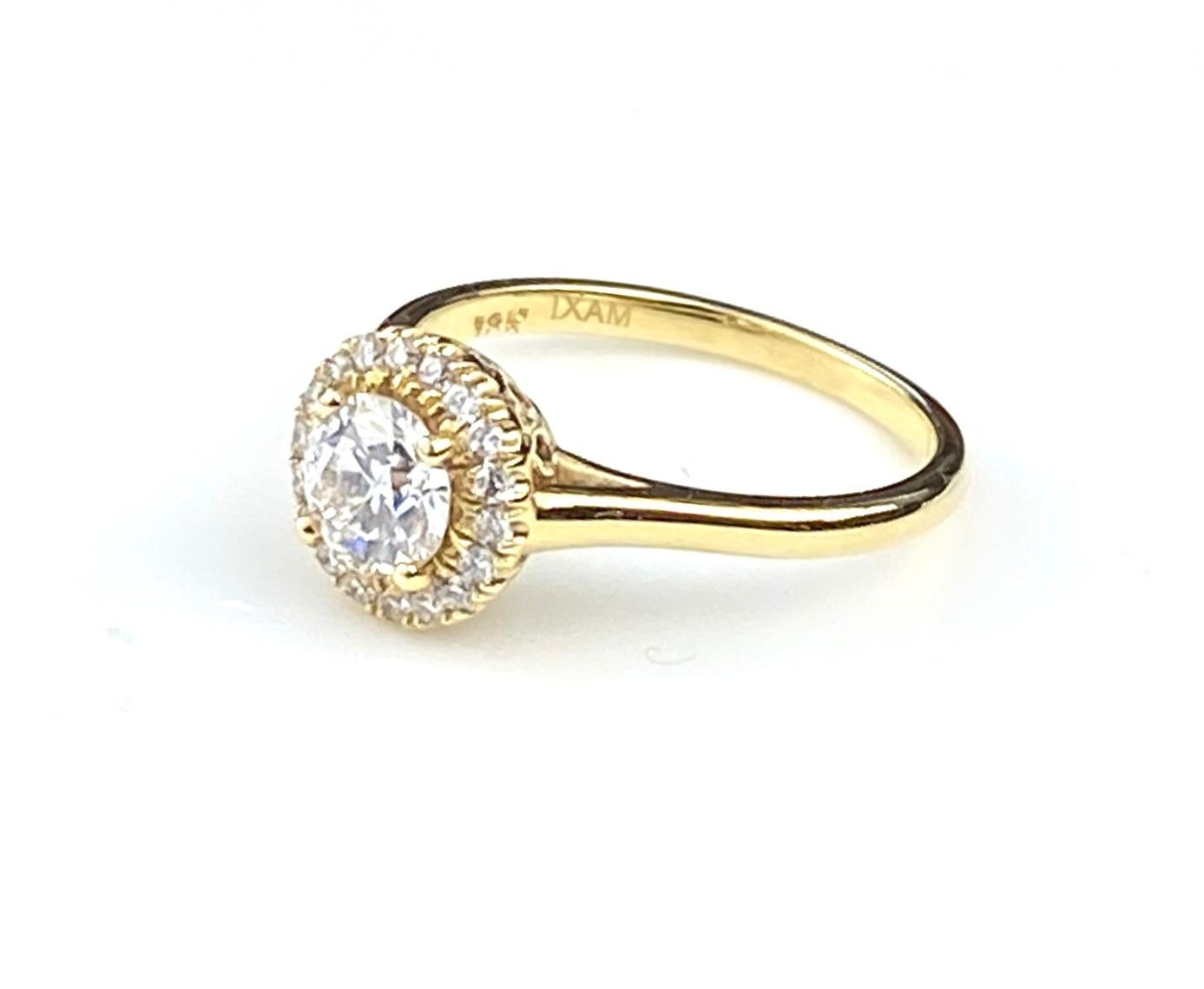 Round cut diamond yellow gold engagement ring with 0.72ct round brilliant center diamond, H SI2 GIA#2151618607. Set in 18kt yellow gold.  Halo set with 18 diamonds totaling 0.15ct, F/G colour and VS/SI1 clarity. Setting includes decorative basket