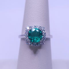 Round Cut Emerald and Diamond Engagement Ring in 18K White Gold