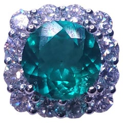 Round Cut Emerald and Diamond Engagement Ring in 18K White Gold