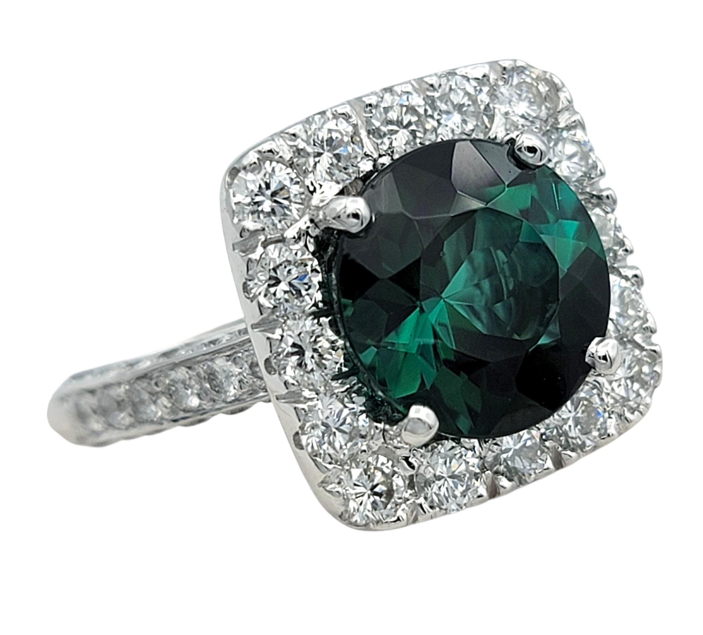 Contemporary Round Cut Green Tourmaline and Squared Diamond Halo Ring in 18 Karat White Gold For Sale