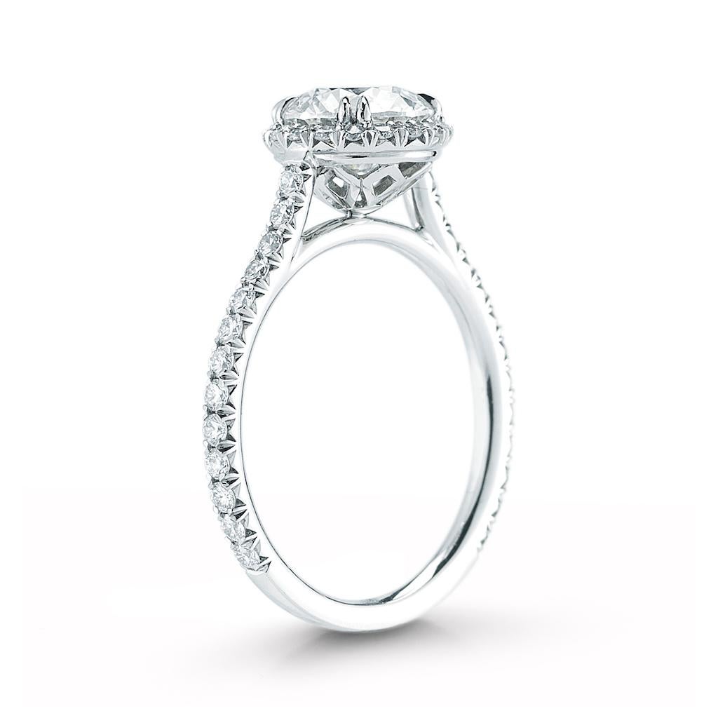 This diamond ring features a round center stone in a halo setting and a pave band. 

HALO RING, Platinum, 1.28 CTW, CNTR 1 RD .83 I SI1 GIA, + 44 BR .45 CTS H SI1, SIZE 6.5, (STYLE #R-10.OE). 

Made to order if not in stock. Our diamonds go beyond