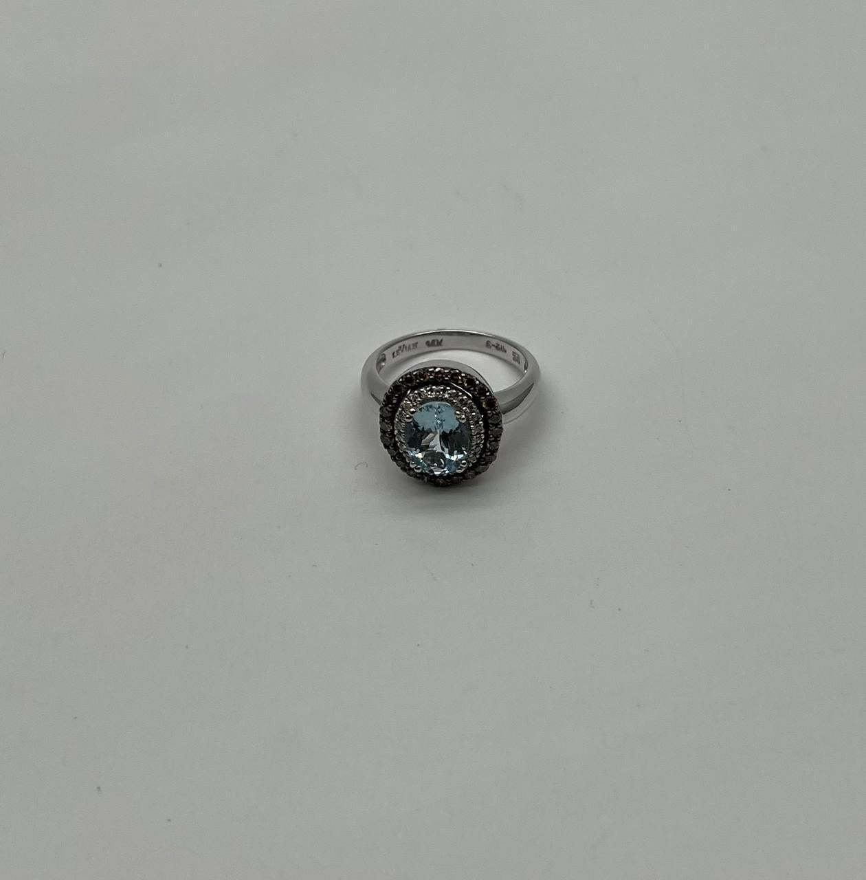 A stunning aquamarine ring.

This exquisite piece features a captivating round cut aquamarine, surrounded by a halo of sparkling diamonds. The aquamarine displays a mesmerizing light blue hue, enhancing its brilliance and clarity. The halo setting