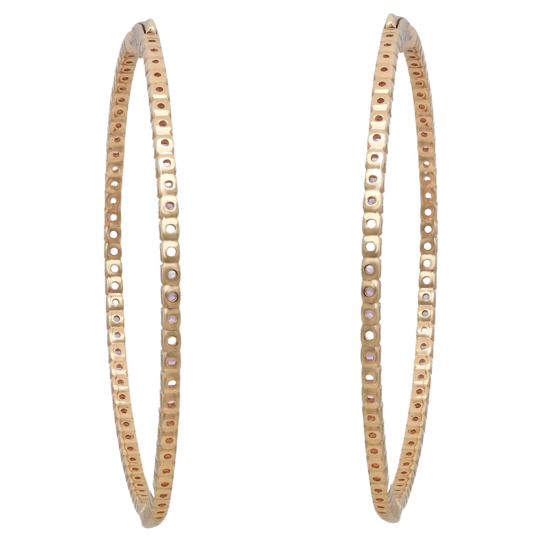 Add a touch of sparkle to your look with these beautiful large inside-out pink sapphire hoop earrings. Expertly crafted in high-quality 14K yellow gold, these earrings feature prong-set round cut pink sapphire, half on the outer hoop and half on the