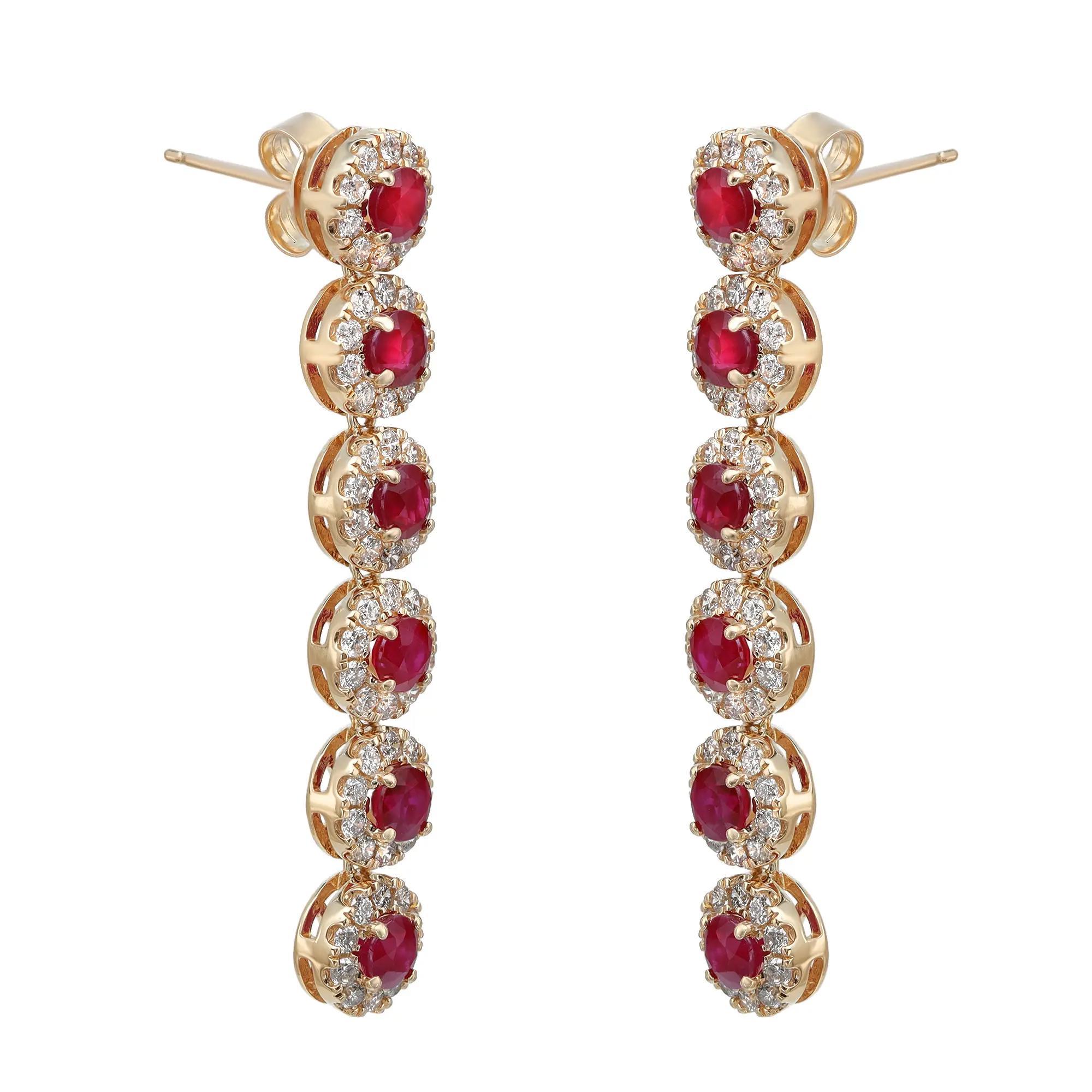 Elevate any attire with these dazzling drop earrings, perfect for any occasion. Crafted in fine 14K yellow gold. These earrings feature prong set round cut ruby with a halo of round brilliant cut diamonds. Total ruby weight: 3.00 Carats. Total
