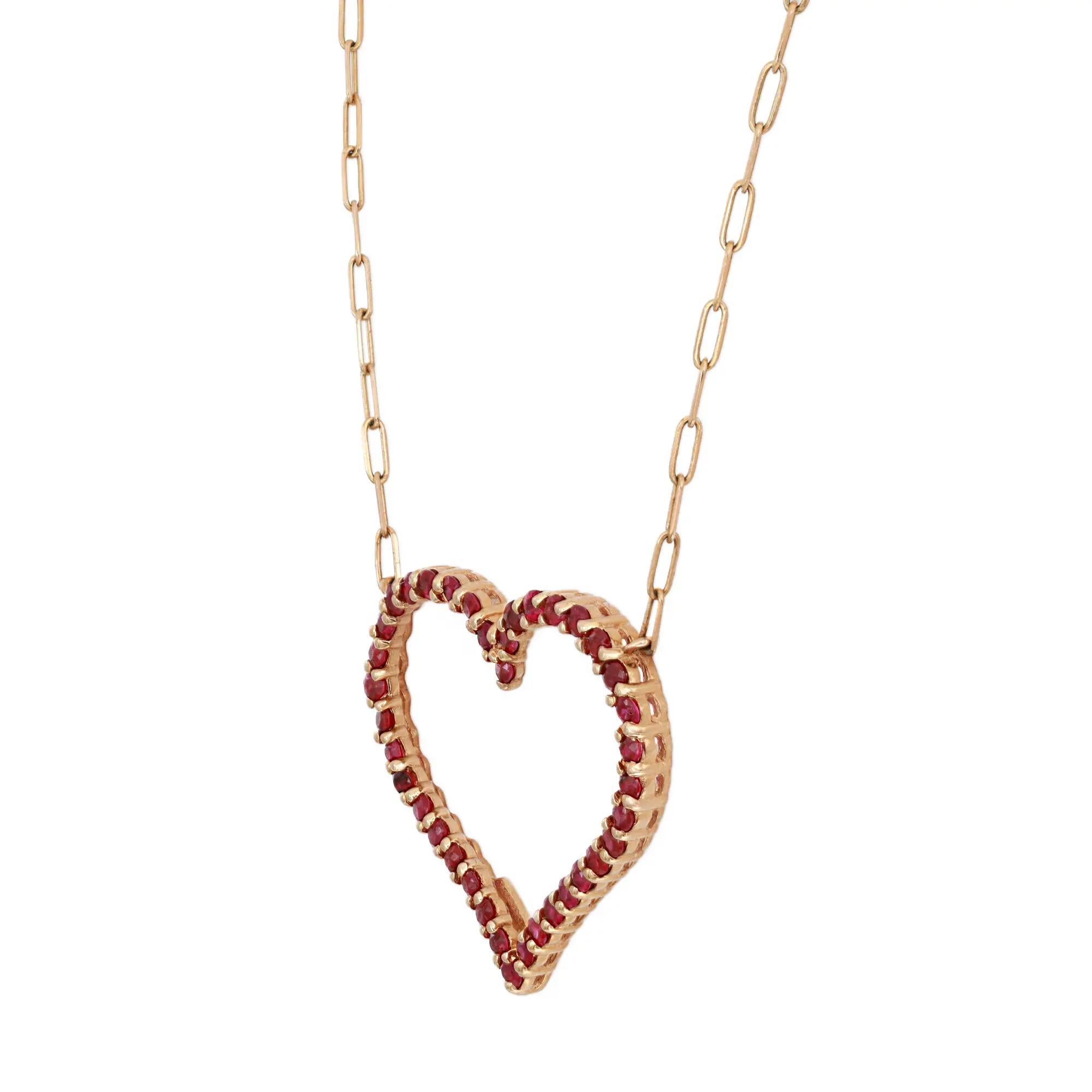 This stunning heart necklace will truly steal the show. A perfect everyday necklace to gift your loved ones. Crafted in 14k yellow gold, it features prong set round cut rubies encrusted in an open heart accompanied with a paper clip link chain.
