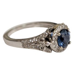 Round-Cut Sapphire Ring with Diamond Halo and Details